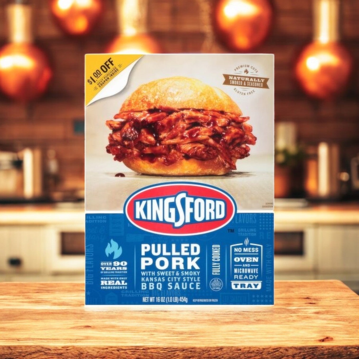 A box of Kingsford BBQ Feast – Pulled Pork, Baby Back Ribs & Burnt Ends sits invitingly on the kitchen counter, surrounded by warm lighting that enhances its mouthwatering allure.