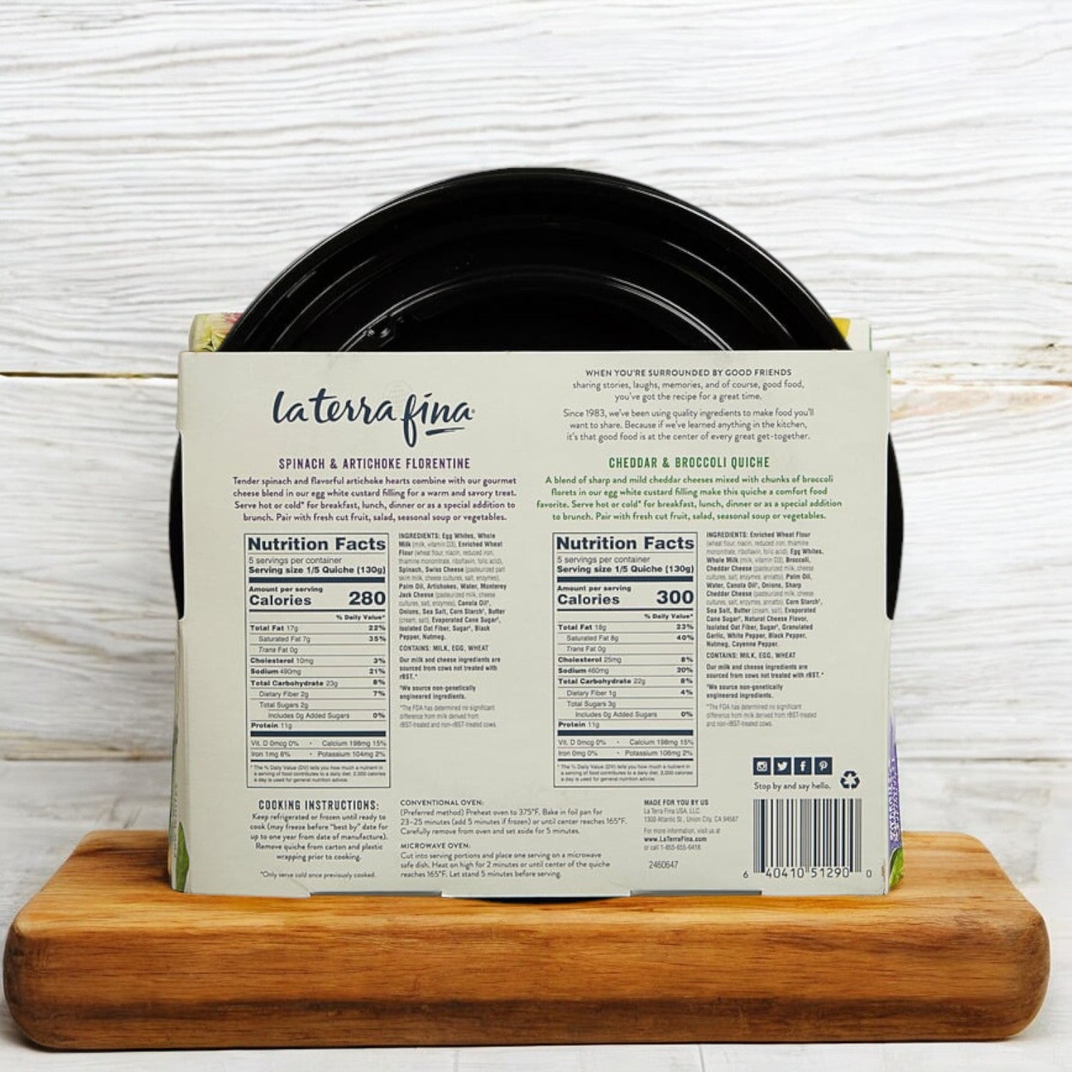 The back of the La Terra Fina Quiche, 2-Pack, 46 oz. - 1 Count package provides nutritional details and cooking instructions for this gourmet quiche, displayed on a wooden cutting board—perfect for those seeking a convenient and delicious frozen meal from La Terra Fina.