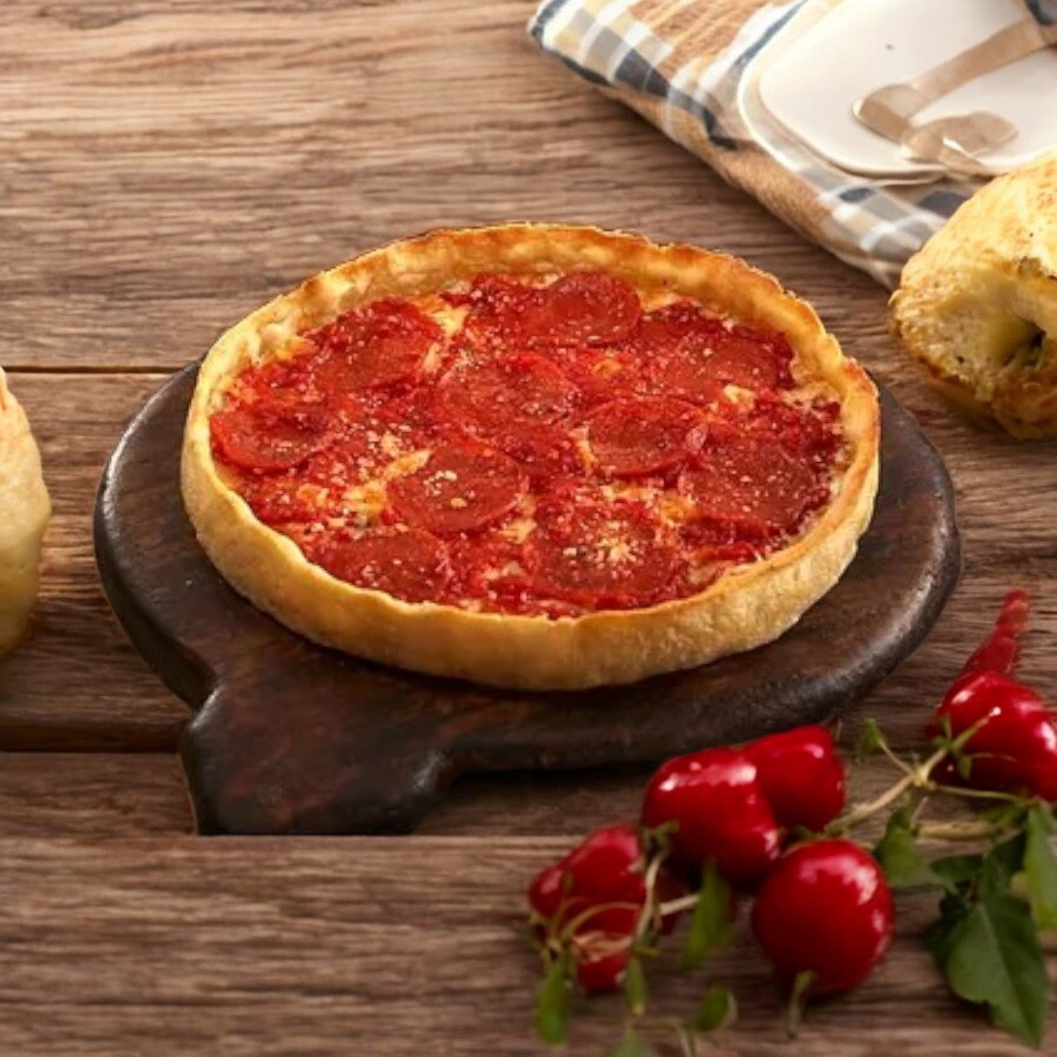 A Lou Malnati's Deep Dish Pizza Pepperoni, 23 oz., is served on a wooden board alongside a checkered cloth and fresh red radishes, bringing to mind the iconic creations from Lou Malnati's.