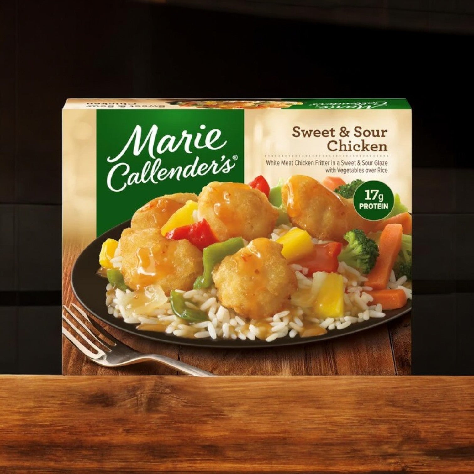 Box of Marie Callender's Sweet & Sour Chicken Frozen Meal, 14 oz., featuring breaded chicken pieces, vegetables, and rice. Contains a satisfying 17g of protein.