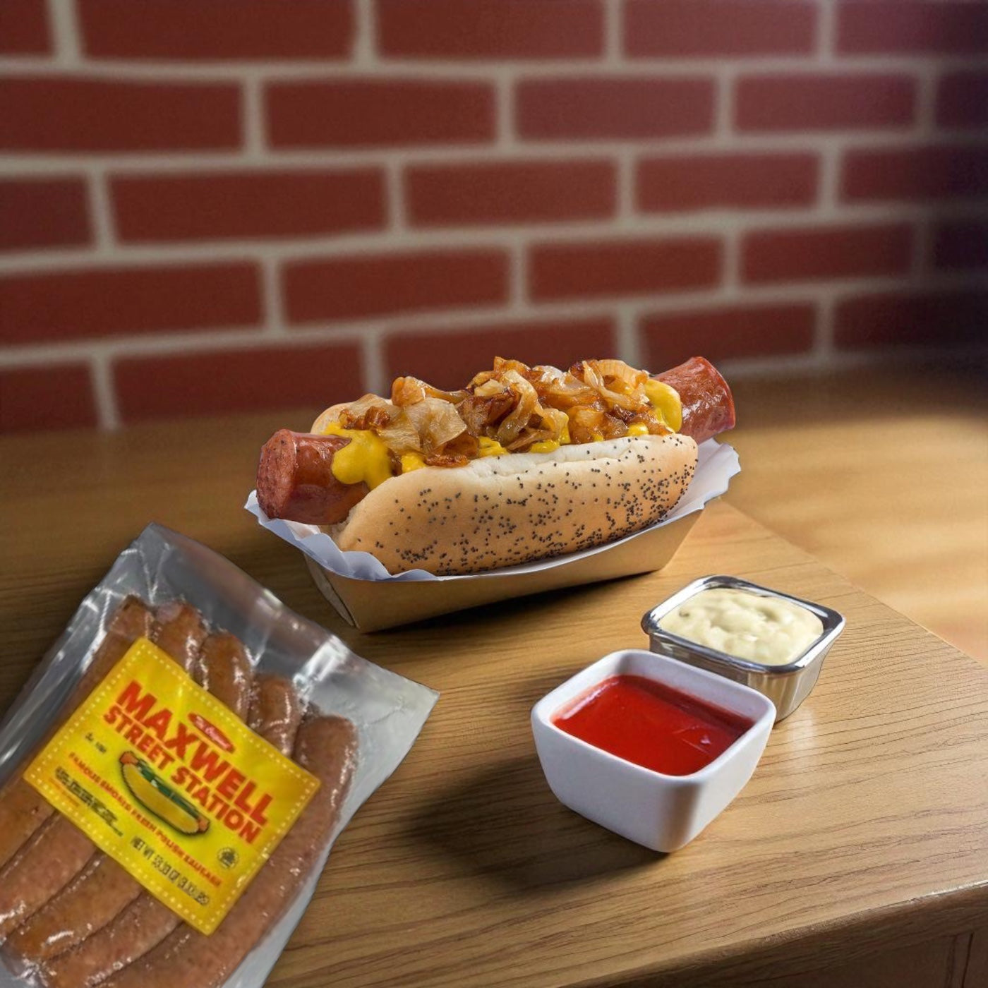 A Vienna Beef Maxwell Street Station Famous Smoked Fresh Polish Sausage hot dog with cheese and fried onions sits on a tray next to ketchup, mayonnaise, and a Maxwell Street sausage pack. Brick wall in the background.