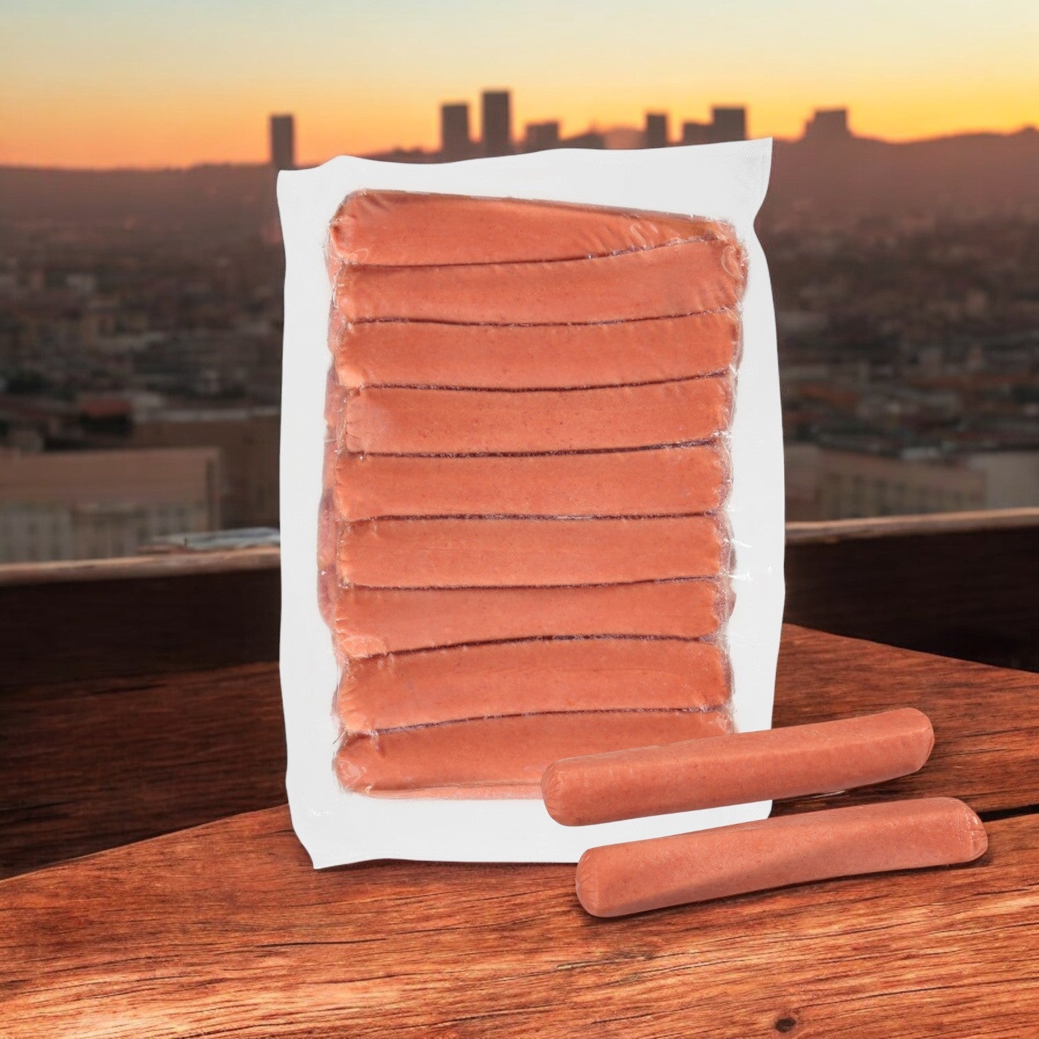A package of Nathan's Famous All-Beef 6" Frankfurters sits on a wooden surface, with a city skyline silhouetted against the vibrant sunset.