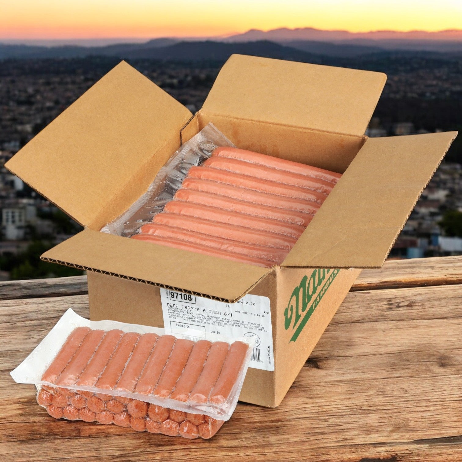 A large open box of Nathan’s Famous Frank All-Beef 6", 60 Count hot dogs sits on a wooden table, with a cityscape and sunset visible in the background.