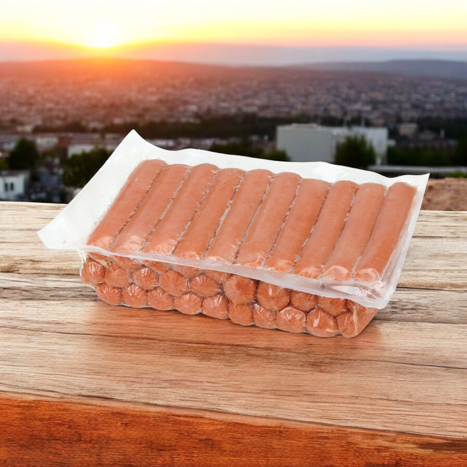 A package of Nathans Famous Frank All-Beef 6", 60 Count sits on a wooden surface, with a stunning cityscape and sunset casting a golden hue in the background.