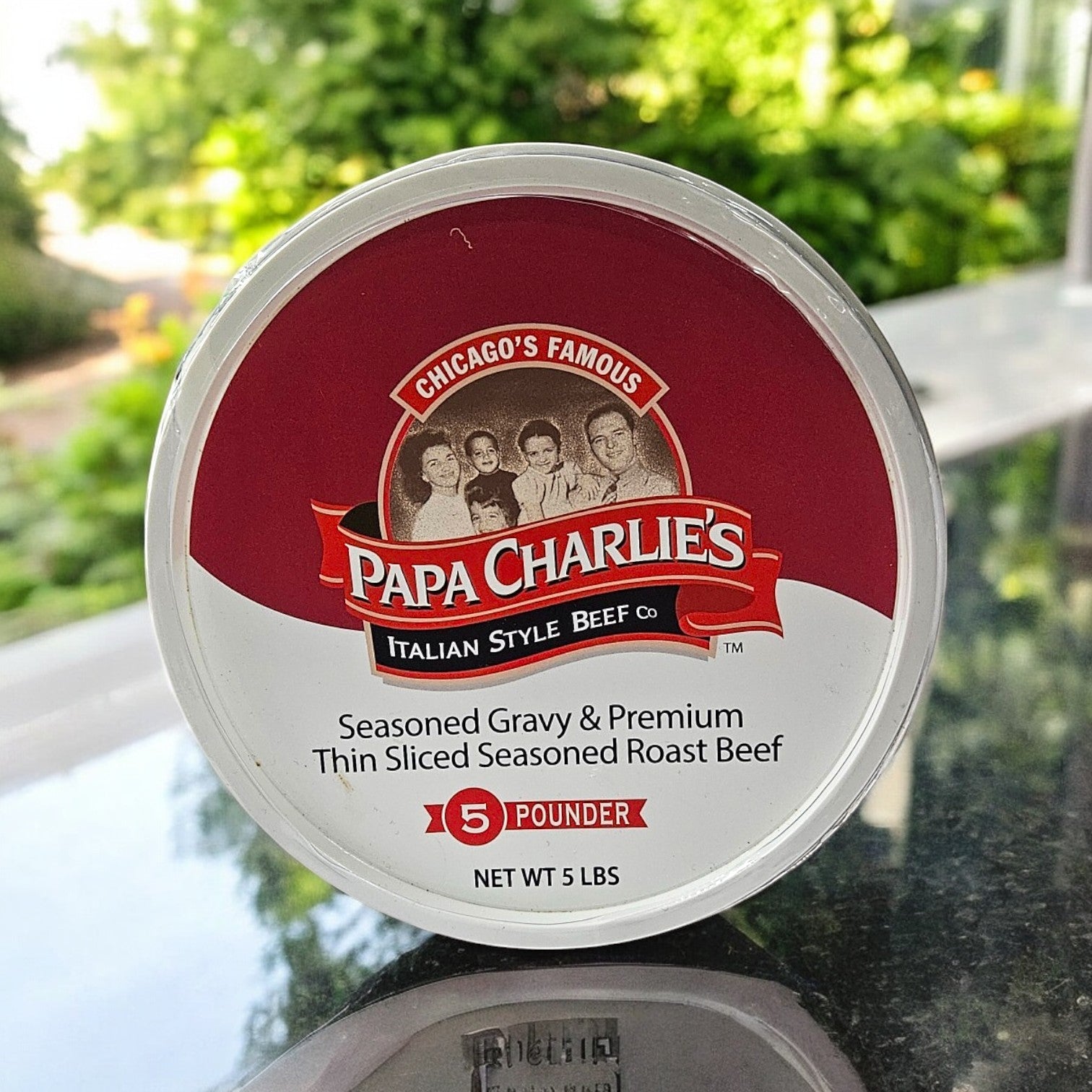 A 5-pound plastic container of Papa Charlie's Thin Sliced Roast Beef, known as Chicago's Famous, offers seasoned gravy-drenched slices.