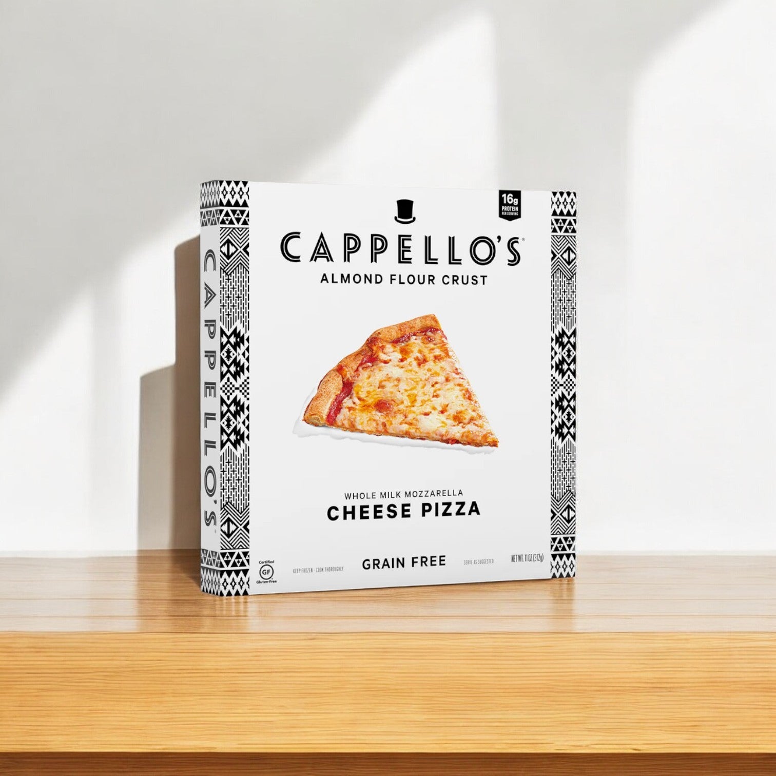 A box of Cappello's Whole Milk Mozzarella (11oz, 1 Count) sits on a wooden surface, showcasing a slice image on the packaging marked as grain-free, highlighting the quality ingredients in each handcrafted pie.