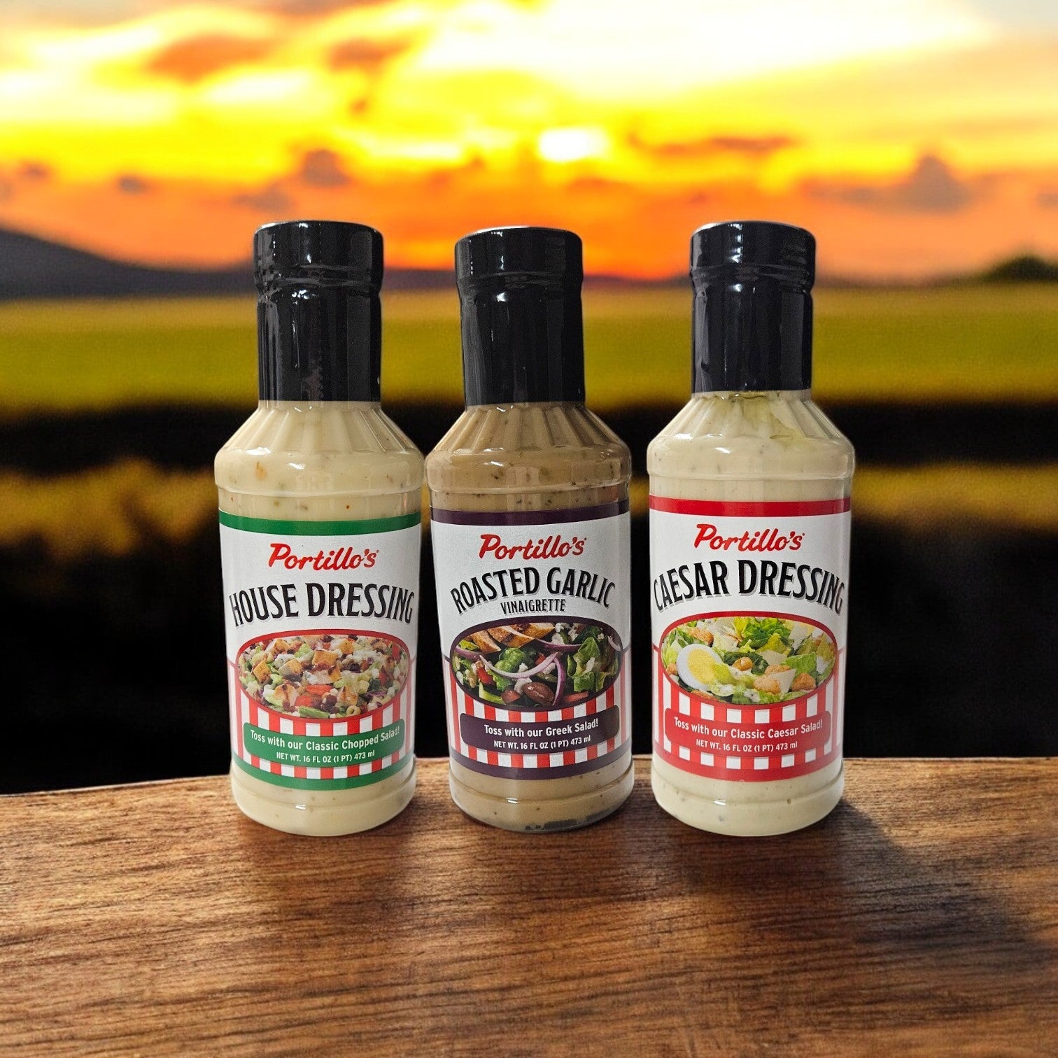 The Portillo's 3-Pack Dressings sits elegantly on a wooden surface against a softly blurred landscape background.
