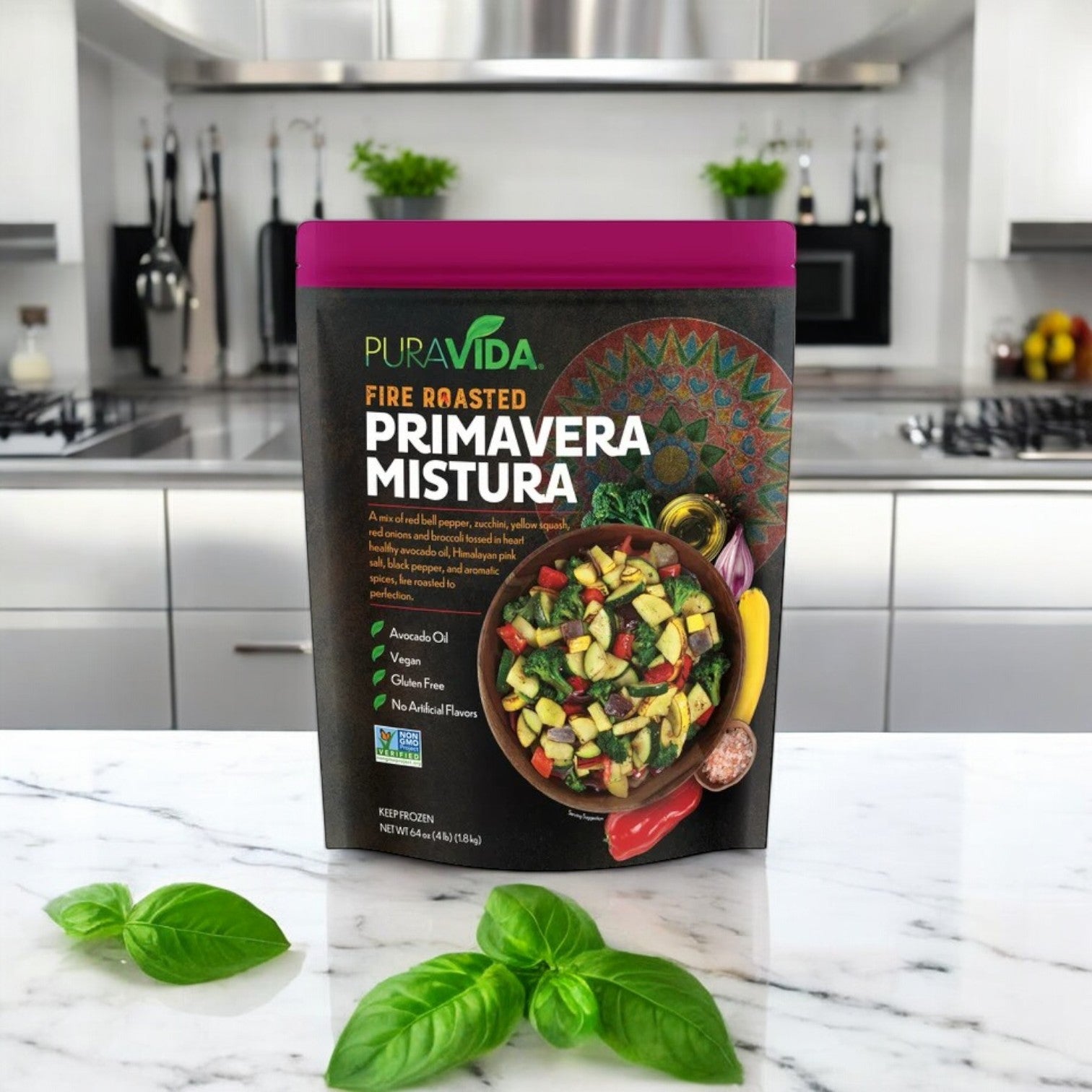 A 64 oz. PuraVida Fire Roasted Primavera Mistura from Pura Vidaa rests on a kitchen counter, garnished with basil. The kitchen features stainless steel appliances and white cabinets, with hints of fire-roasted Brussels sprouts in the air.