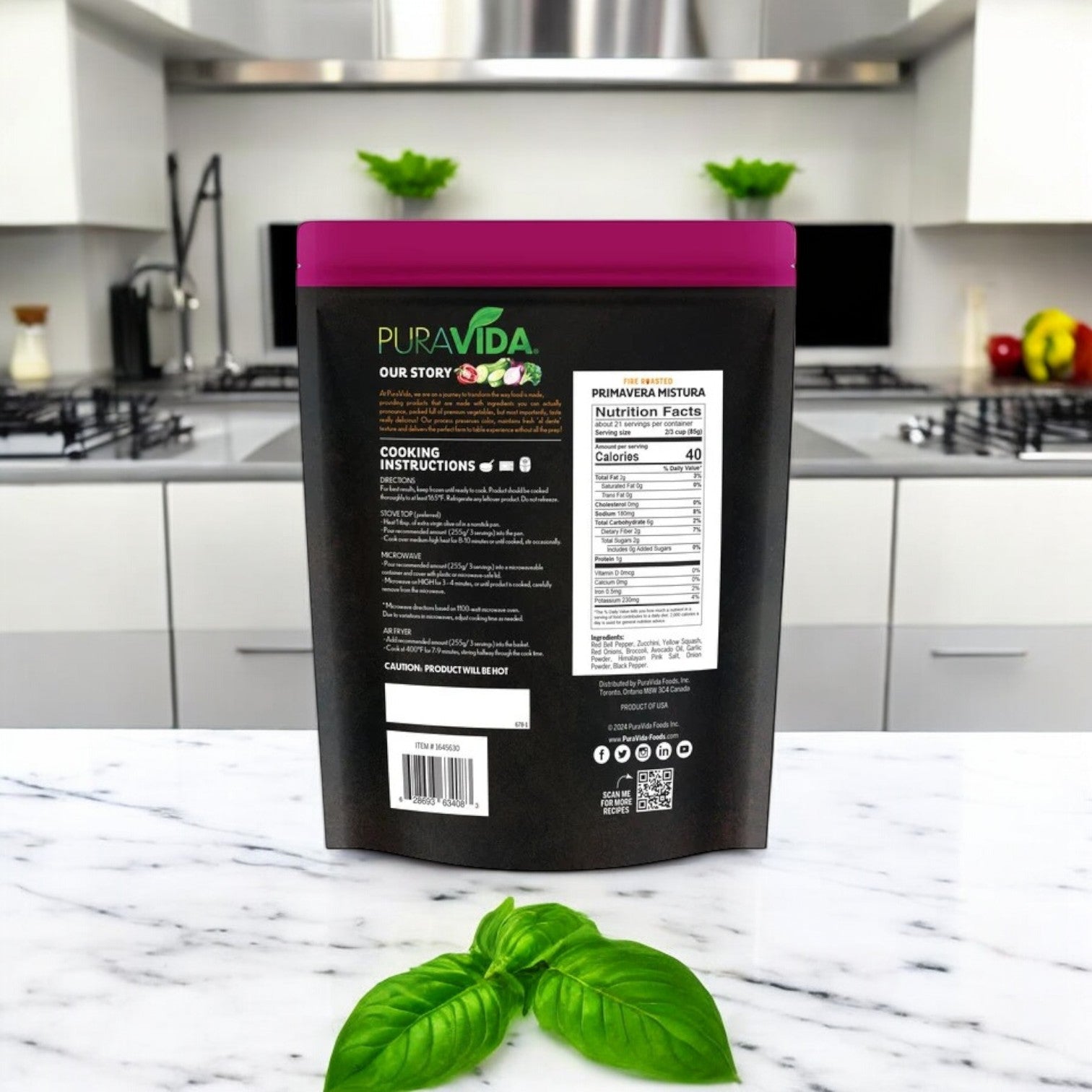 A 64 oz. package of PuraVida Fire Roasted Primavera Mistura adorns a modern kitchen counter alongside basil leaves, with sleek appliances in the background, ideal for culinary creativity like fire-roasted Brussels sprouts.