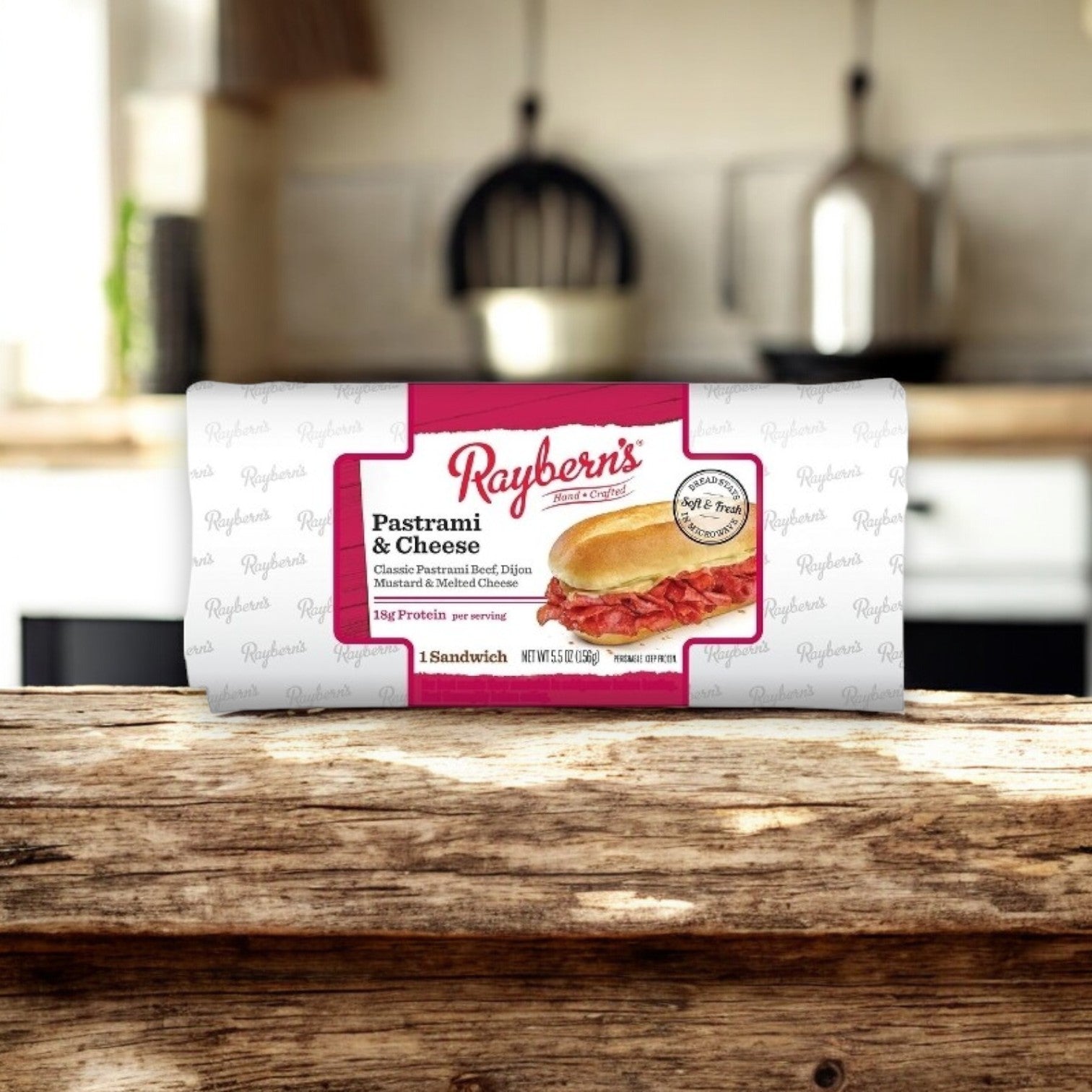 Raybern's 5.5 oz Individually Wrapped Pastrami & Cheese Sandwich, featuring classic pastrami, Dijon mustard, and cheese with high protein content, is ideally designed for quick enjoyment on a kitchen counter as it's microwaveable for convenience.