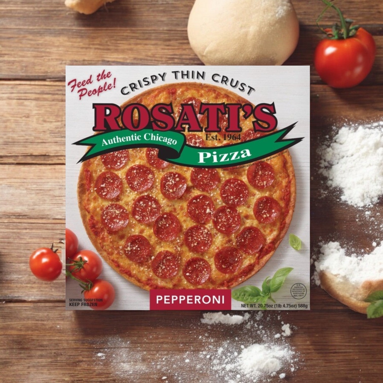 A box of Rosati's Pizza Crispy Thin Crust Pepperoni - 20.75 oz rests on a wooden surface, accompanied by fresh tomatoes, flour, and garlic.