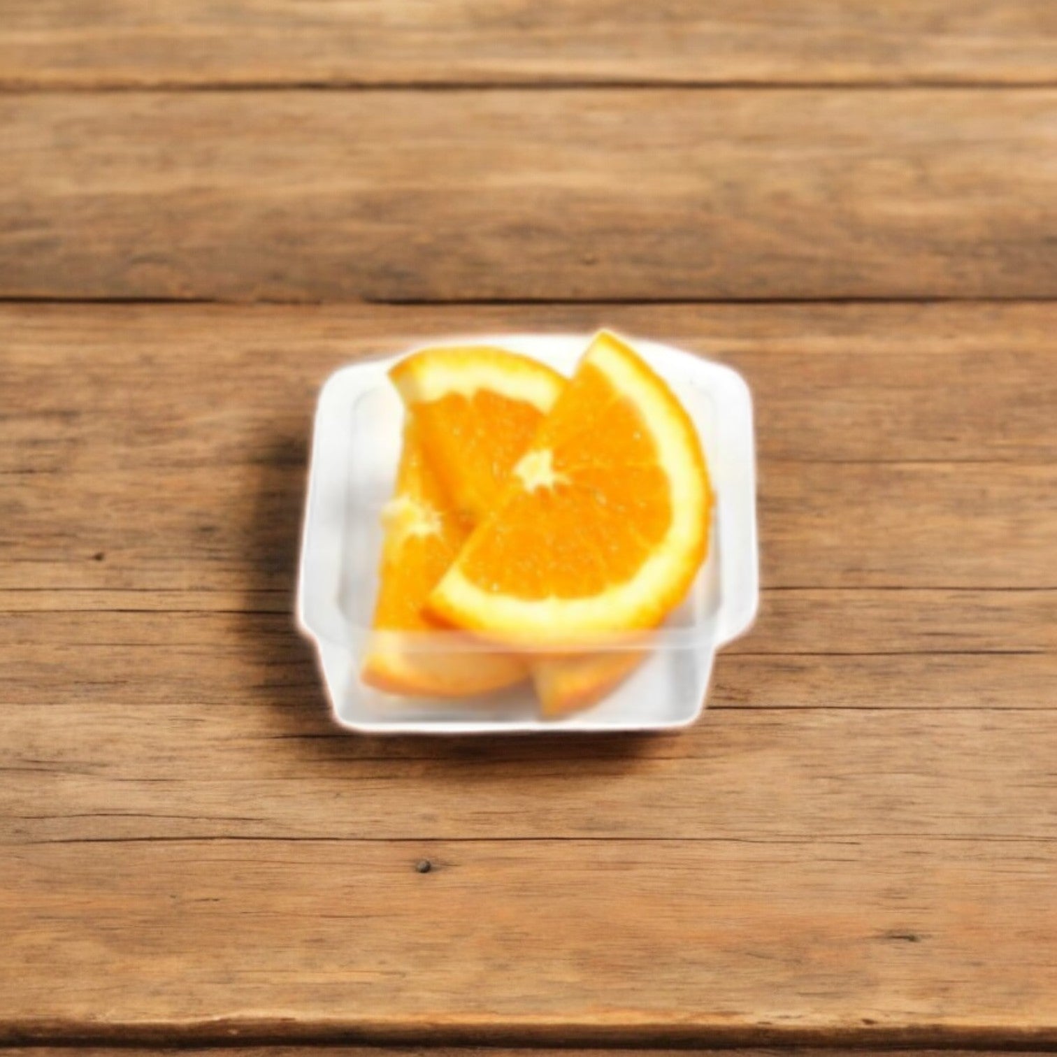 Three slices of Easy Lunches Sliced Oranges, 2.5 oz., displayed on a white square dish over a wooden surface, packed with Vitamin C delight.