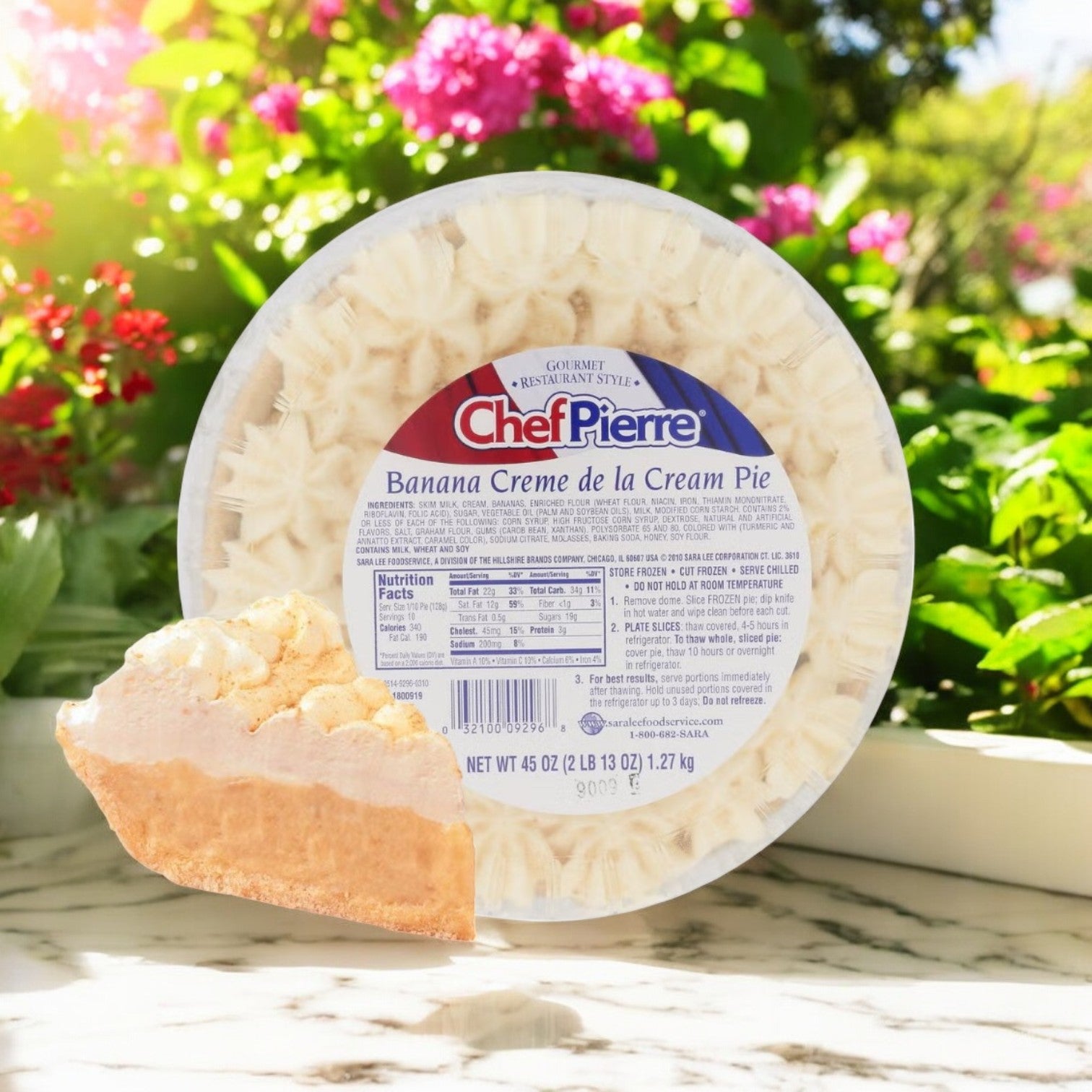 The Chef Pierre Banana Crème de la Cream Pie, a 10-inch frozen dessert delight, features a creamy banana filling. Displayed on marble, it comes in sleek packaging with a slice missing and delicate flowers in the background. Each case includes 4 pies.