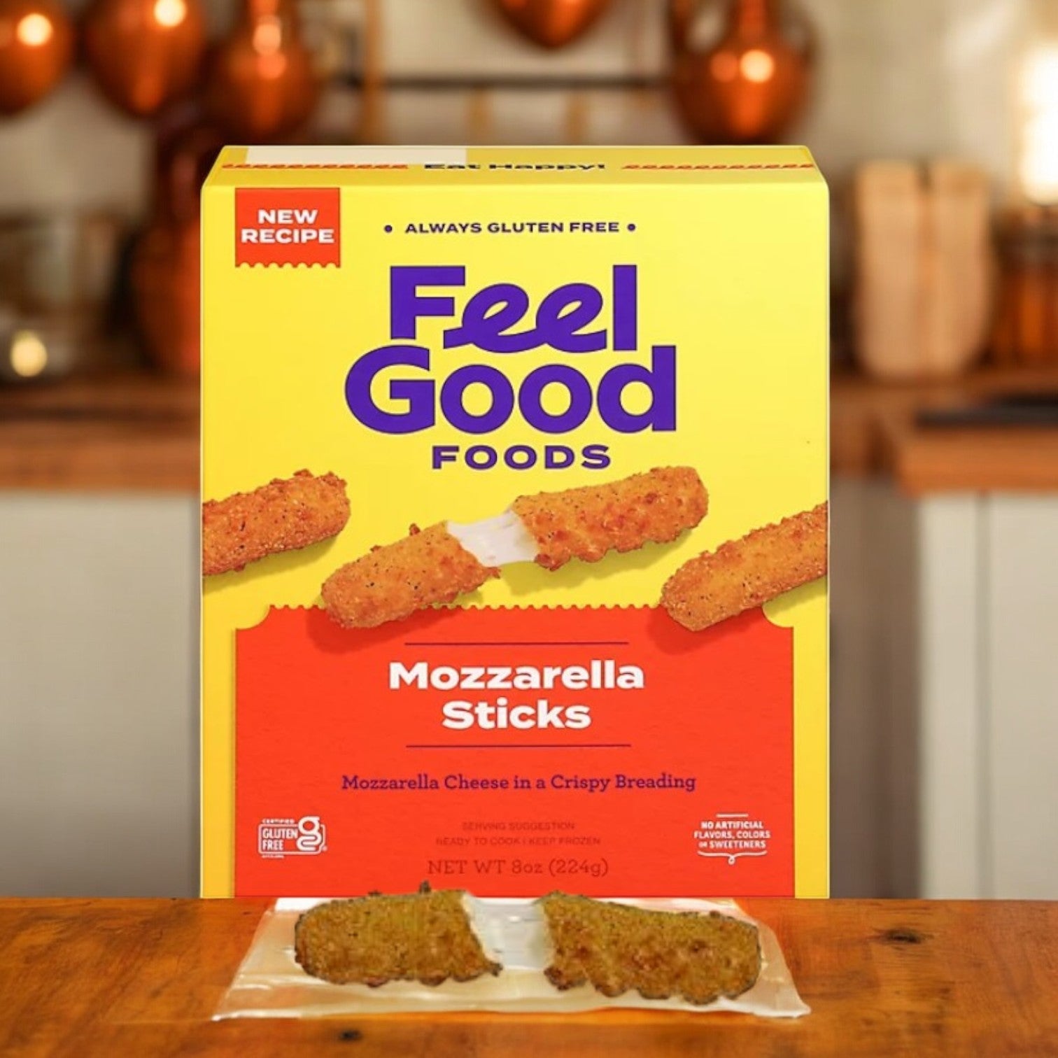 The Feel Good Foods Gluten-Free Breaded Mozzarella Sticks, -1ct,-8oz., rest on a wooden table with two sticks in clear packaging displayed in front. These gluten-free delights are perfect comfort foods and shareable snacks for any occasion.