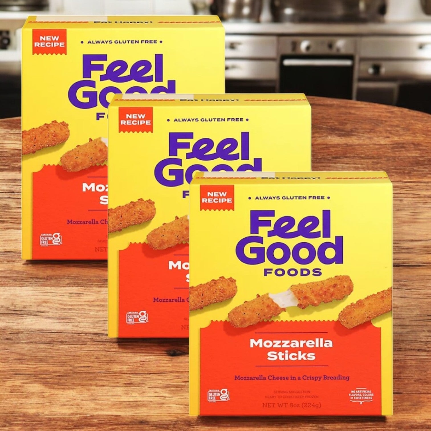 Three boxes of Feel Good Foods Gluten Free Breaded Mozzarella Sticks are showcased on a wooden kitchen surface, highlighting their appeal as a comforting gluten-free snack.