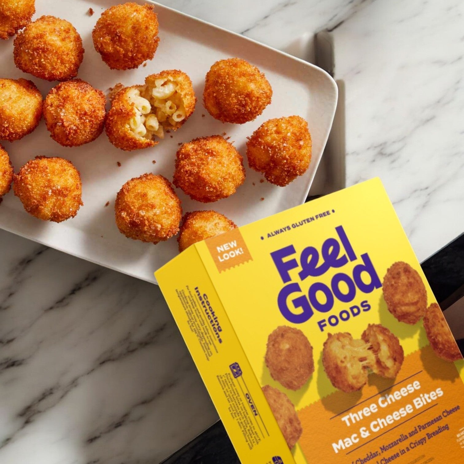 Feel Good Foods' Three Cheese Mac & Cheese Bites, 8 oz., next to a snack plate of bites on a marble surface.