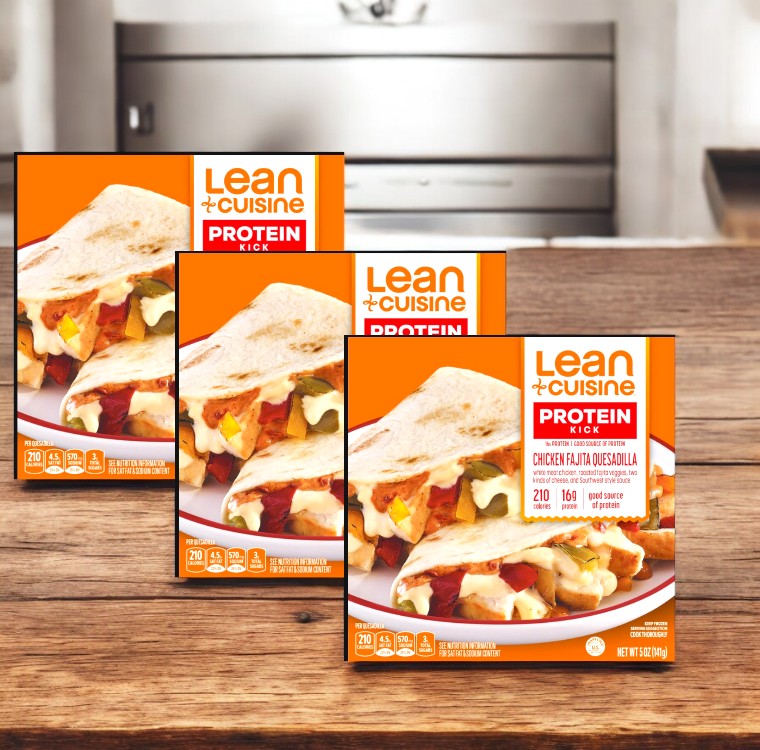 Three Lean Cuisine Chicken Fajita Quesadilla-5 Oz-3 Count boxes are elegantly displayed on a wooden countertop in a cozy kitchen.