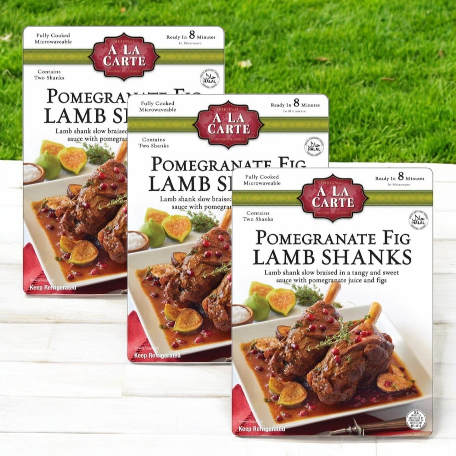 Displayed are three 2-count packs of A La Carte Pomegranate Fig Lamb Shanks, each pack showcasing a mouthwatering image of perfectly glazed, tender lamb with sauce and vegetables, promising a unique culinary experience.