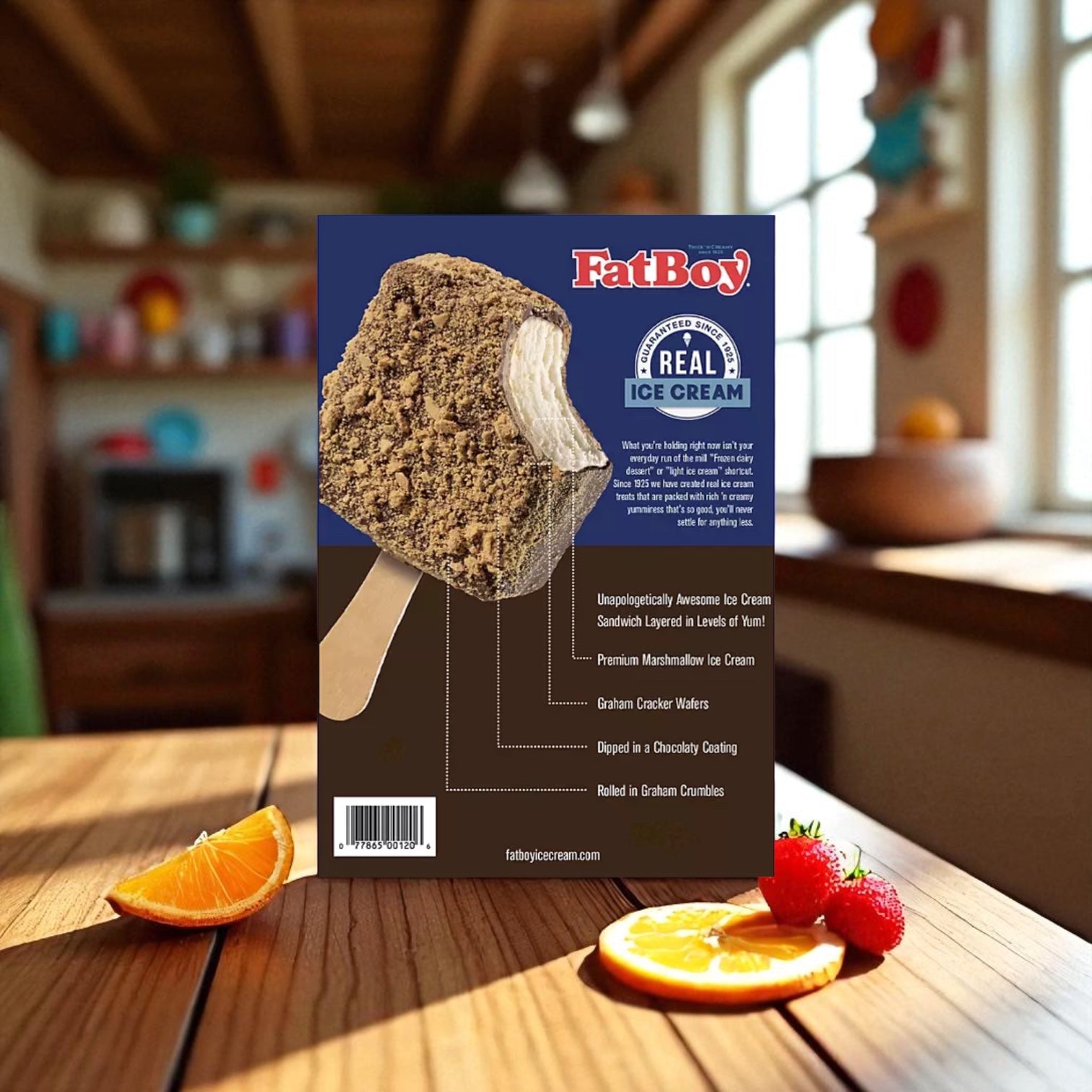 A box of FatBoy Smores Sandwich Bars, 12 Count, rests on a wooden table with oranges and strawberries in front; sunlight streams into the kitchen, capturing the classic frozen novelty bar vibe.