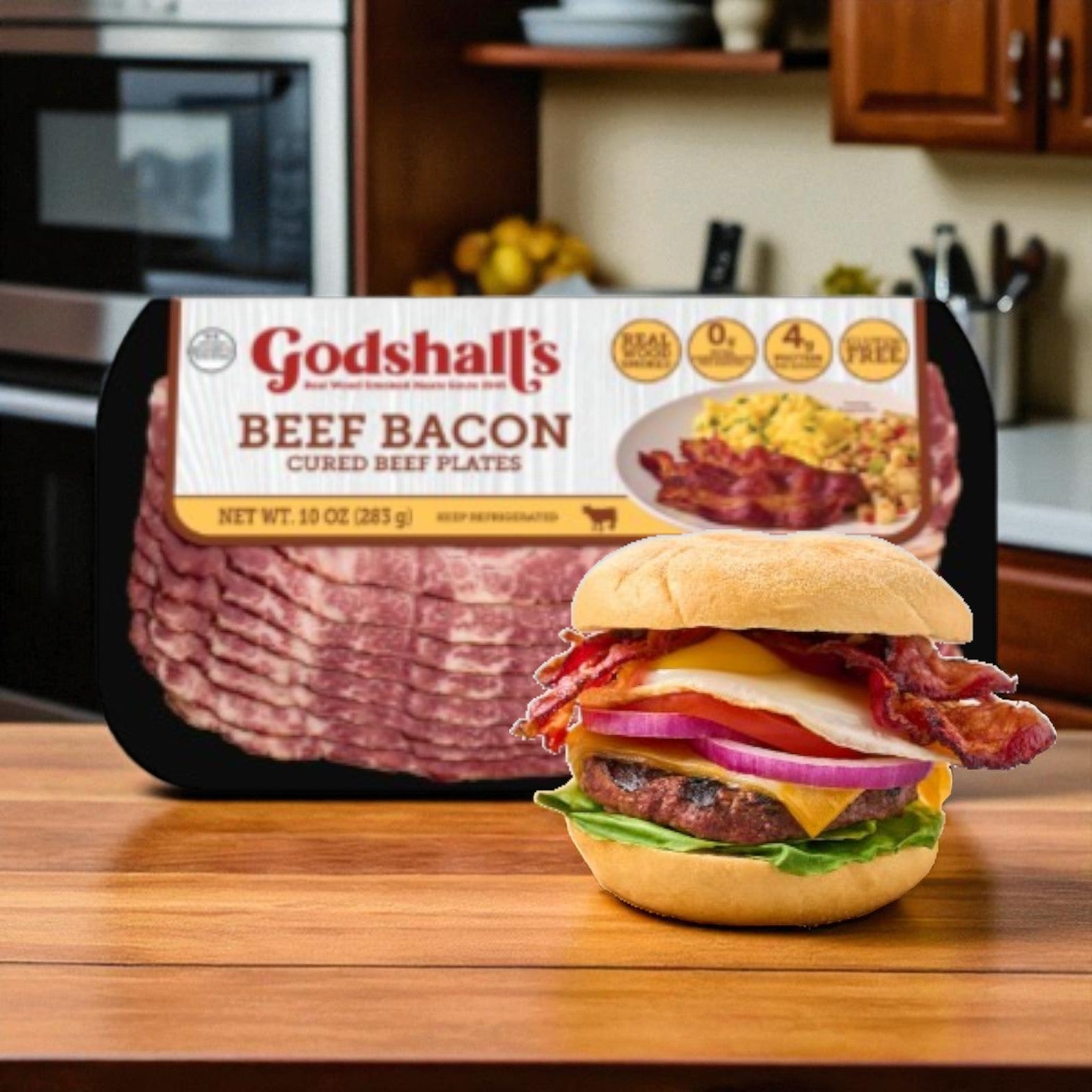 A pack of Godshall's Beef Bacon-10 Oz sits on a kitchen counter behind a keto-friendly cheeseburger topped with Godshall's beef bacon, lettuce, tomato, onion, and cheese.