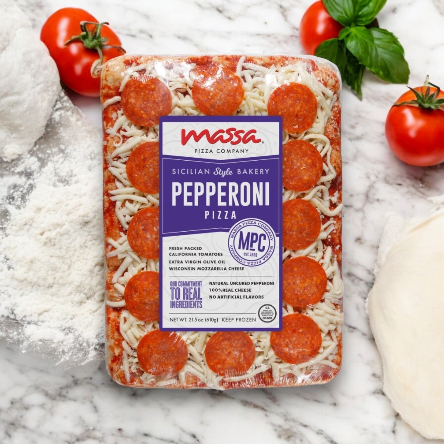 Massa Pizza Company Pepperoni Pizza – 21.5 oz. by Massa Pizza showcases artisanal craftsmanship on a marble surface, surrounded by fresh tomatoes, basil, flour, and rich dough—highlighting the premium ingredients that make every bite extraordinary.