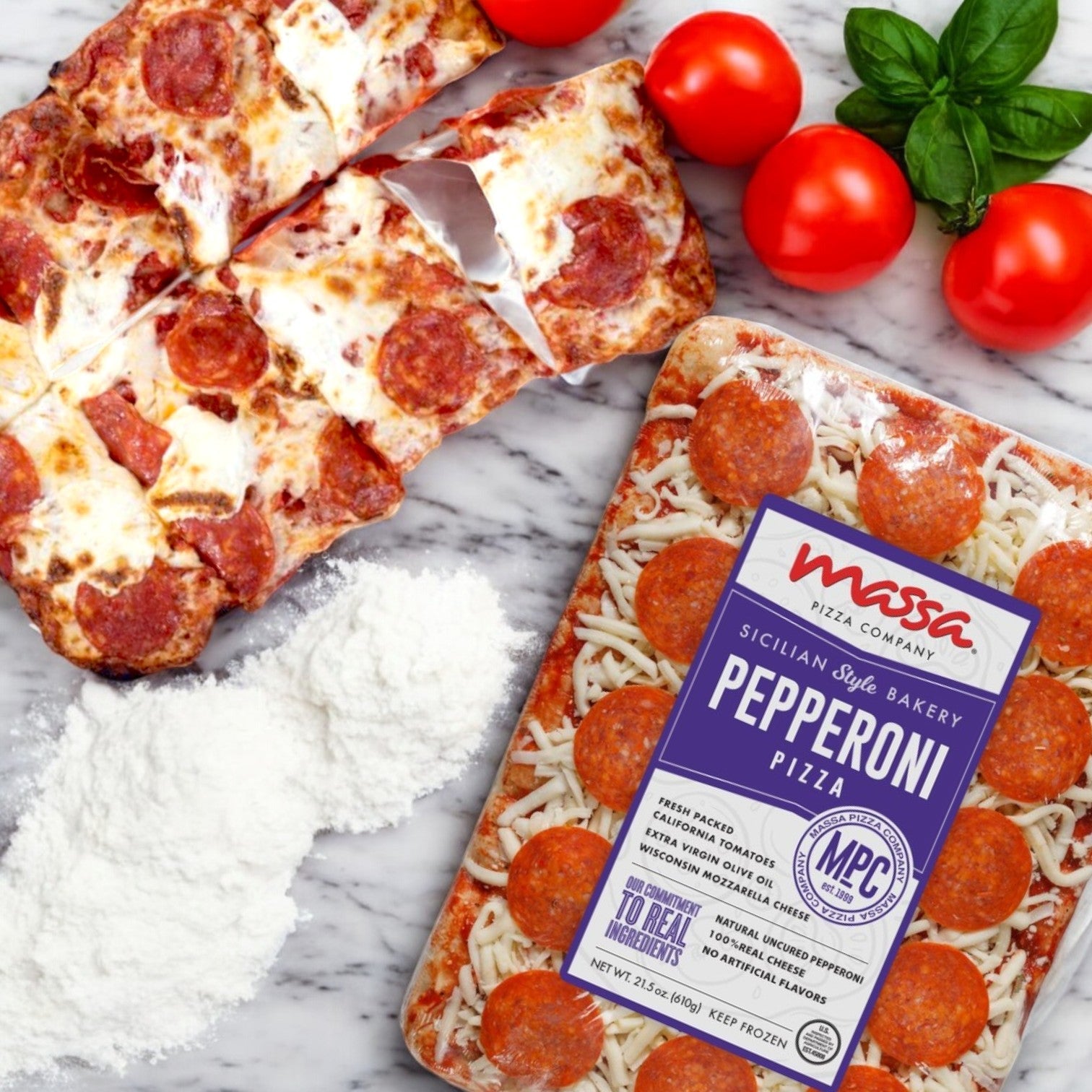 Massa Pizza Company's Pepperoni Pizza – 21.5 oz. package highlights artisanal craftsmanship on a marble surface, complemented by a baked slice, flour, tomatoes, and fresh basil, showcasing the premium ingredients in Massa Pizza's delightful creations.