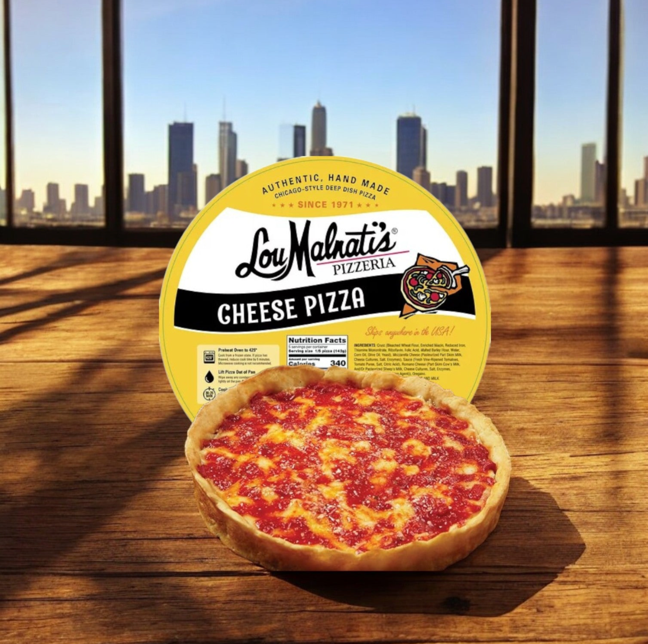 A Lou Malnati’s Chicago’s Best Combo Kit—featuring deep dish pizza and Vienna Italian beef—rests on a wooden table with its packaging, city skyline visible through large windows in the background.