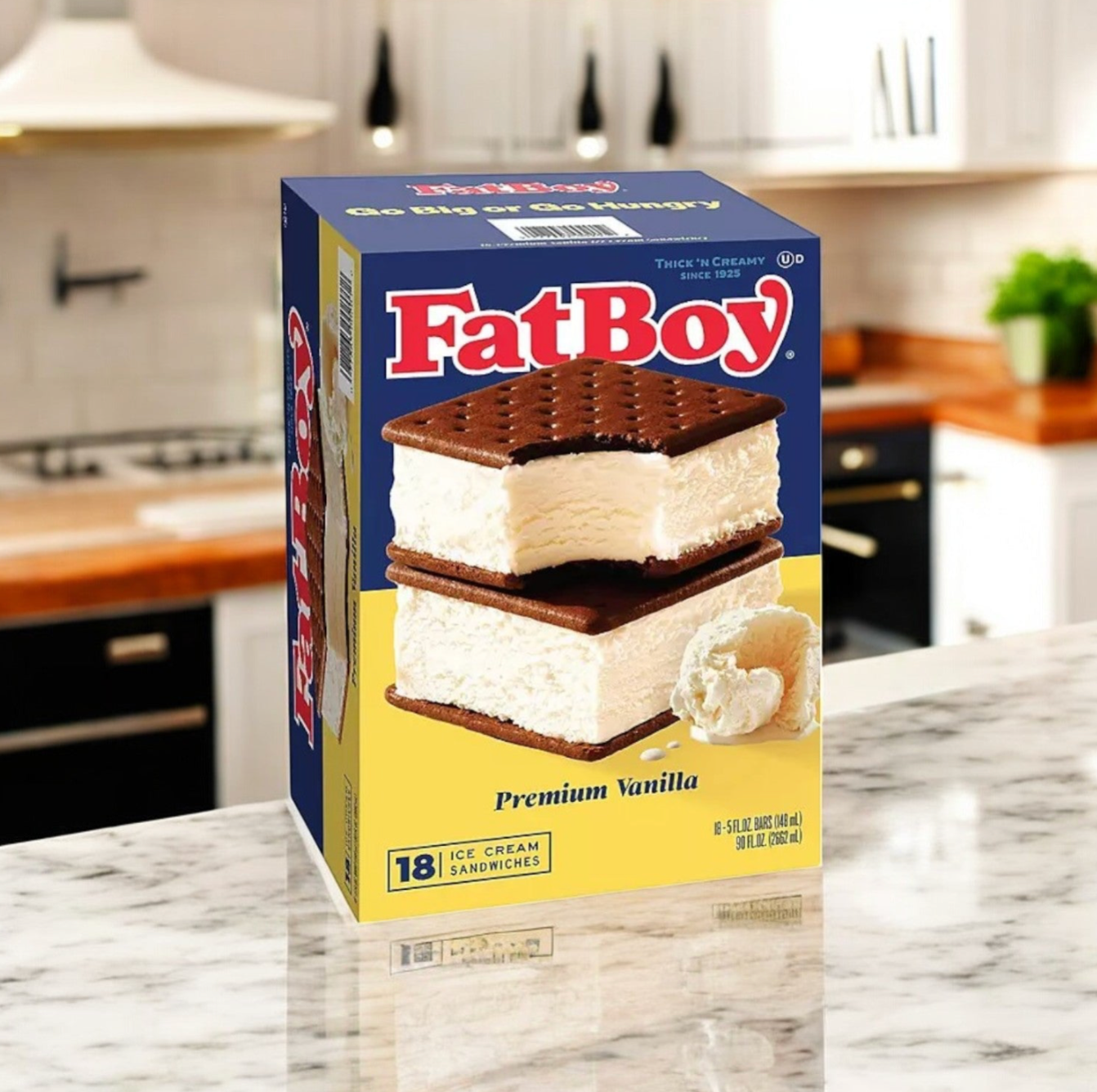A box of FatBoy Smores Sandwich Bars & Premium Vanilla Ice Cream Sandwich Combo rests on a marble kitchen counter, with a modern kitchen in the background.
