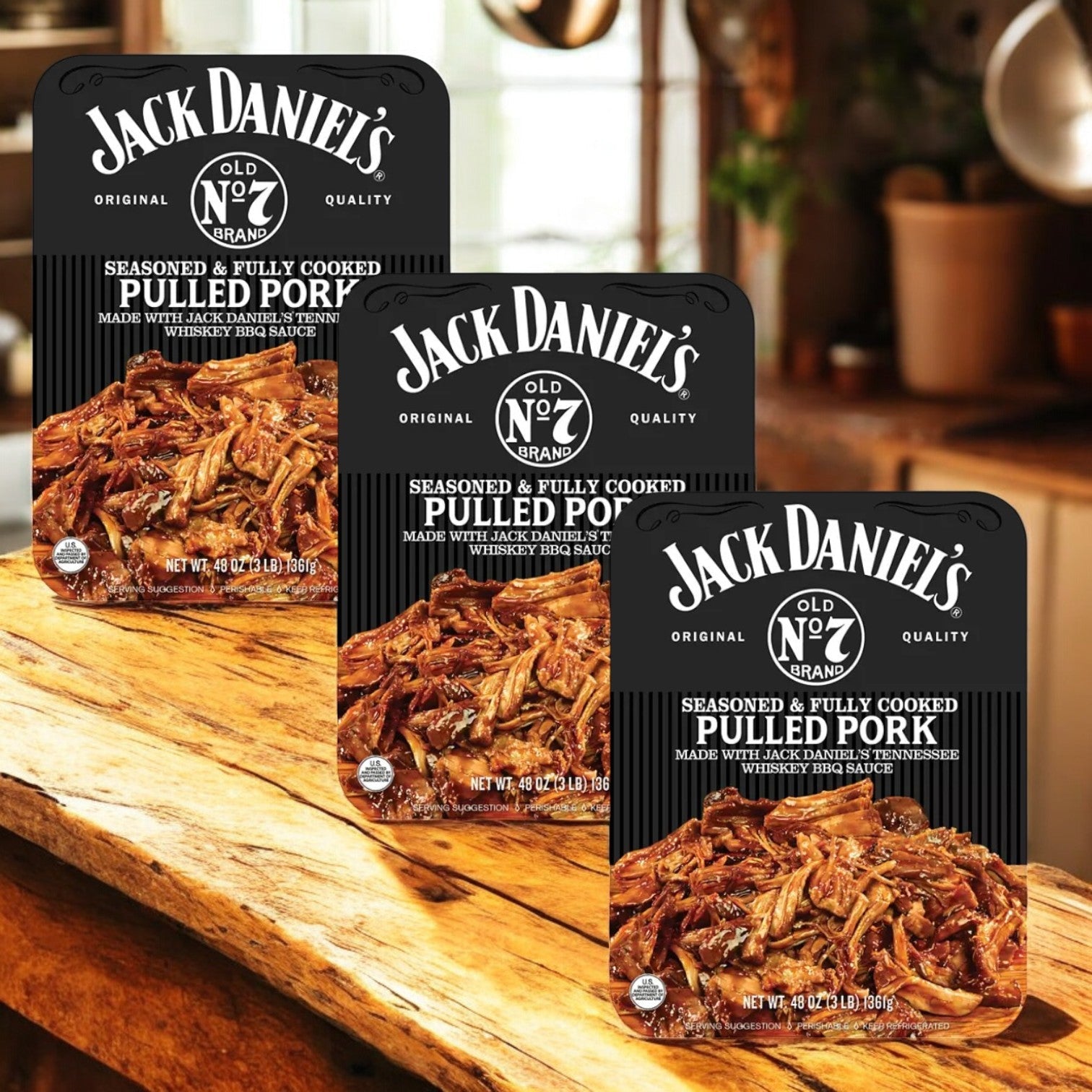 Three Jack Daniels Pulled Pork packages (3 lbs, 3 count) are displayed on a wooden surface, showcasing the savory taste of Tennessee Whiskey BBQ sauce.