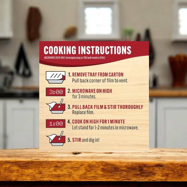 A sign with cooking instructions for microwaving a Smart Ones Santa Fe Rice & Beans, 9 oz. - 1 Count. The steps include venting, microwaving, stirring, cooking again, and stirring once more, with specific times and actions for each step.