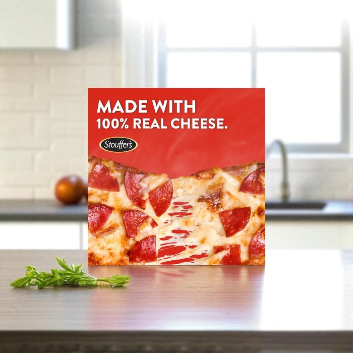 A box of Endless Market DRAFT - Stouffer’s Pepperoni French Bread Frozen Pizza (1 Count) rests on a kitchen counter, showing the text: "Made with 100% real cheese.