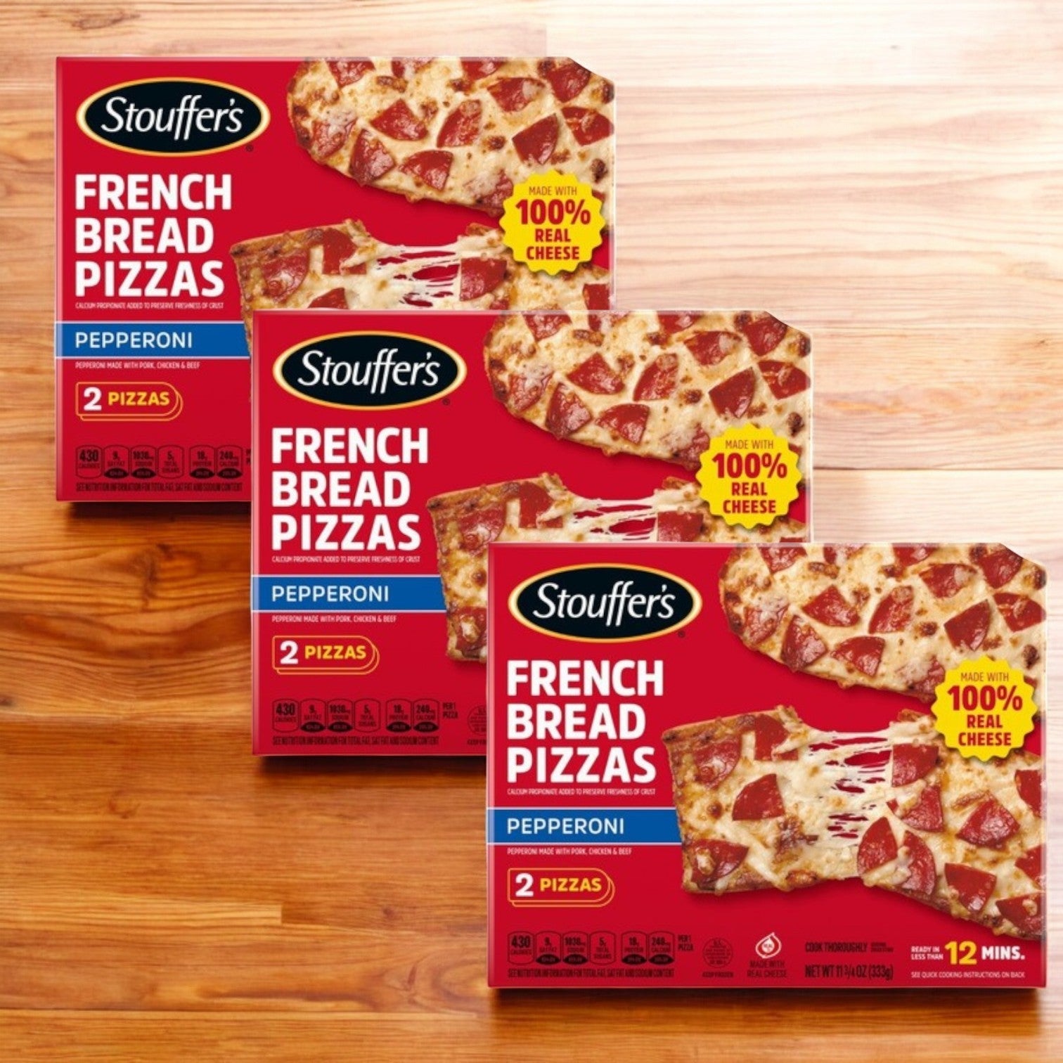 Three boxes of Stouffer's Pepperoni French Bread Frozen Pizza, each containing two pizzas and featuring "100% real cheese" on the packaging, are displayed on a wooden surface.