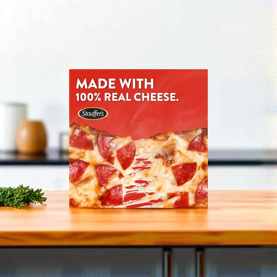 A box of DRAFT - Stouffer’s Pepperoni French Bread Frozen Pizza - 1 Count by Endless Market sits on a kitchen counter with the label "Made with 100% real cheese," making it an ideal choice for a quick, tasty meal.