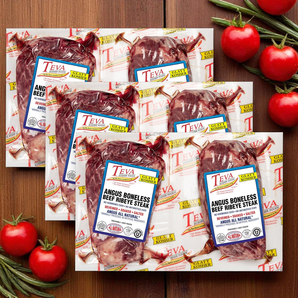 Three packs of Teva Kosher Foods Glatt Kosher Angus Boneless Ribeye Steak (2-count each) are arranged on a wooden surface with tomatoes and rosemary, highlighting premium cuts for your next meal.