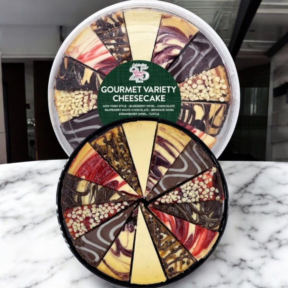 Two 10-inch, 14-cut variety cheesecakes from The Father’s Table, crafted with premium ingredients and featuring assorted flavors and toppings, are displayed on a marble surface.