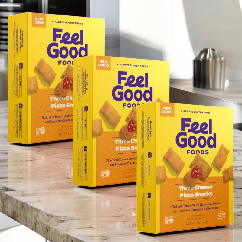 Three boxes of Feel Good Foods Three Cheese Pizza Snacks are on the kitchen counter, featuring a gluten-free crust with savory tomato sauce and a blend of mozzarella, Romano, and provolone cheese.