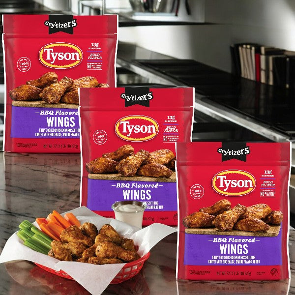 Three packs of Tyson Any'tizers BBQ Flavored Chicken Wings, 1.37 lb each, are on the counter, while a basket of crispy bone-in chicken wings with celery, carrots, and smoky BBQ sauce awaits in front.