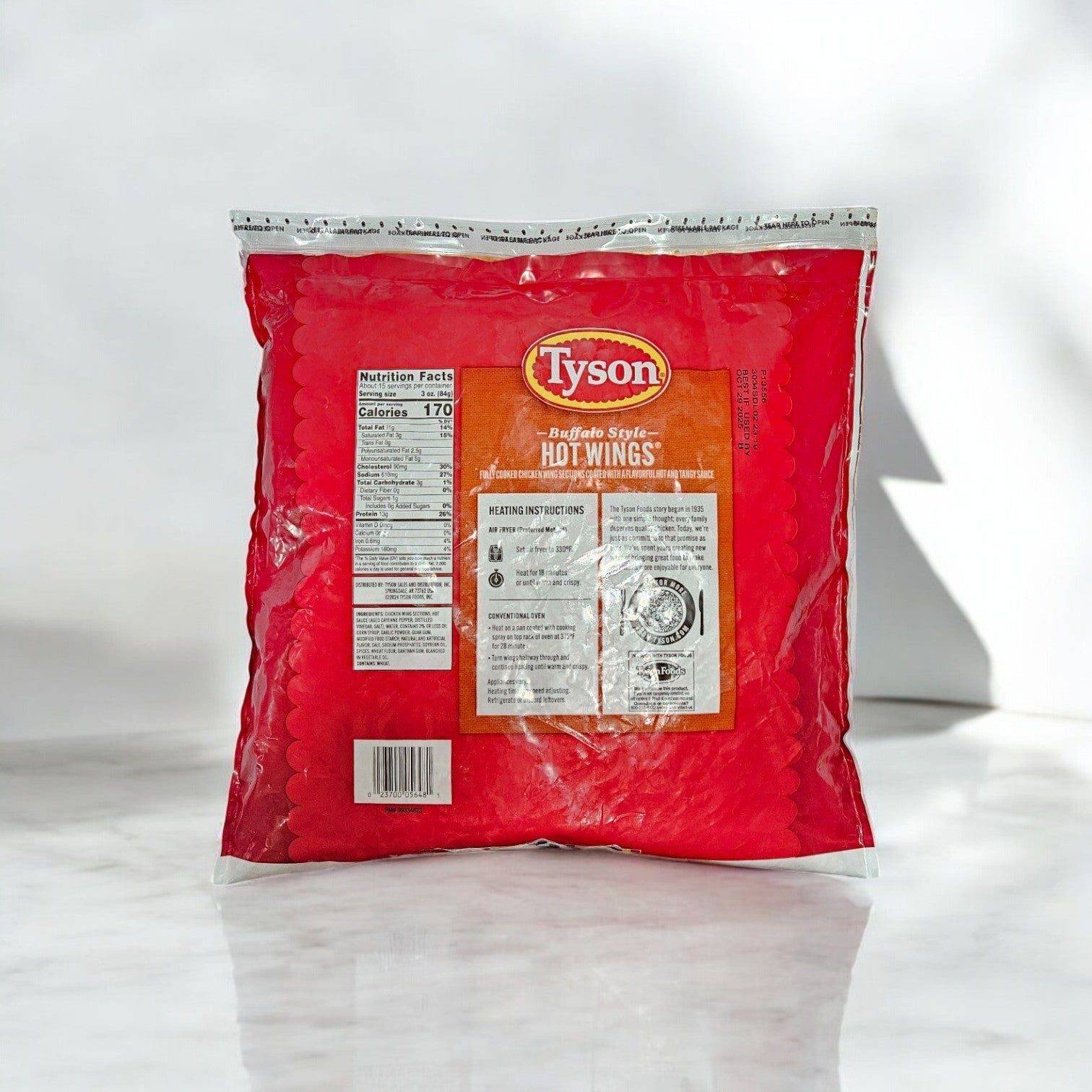A package of Tyson Buffalo Style Hot Wings, Fully Cooked Chicken Wing, 4lbs. - 3 Bags contains tender wings in spicy Buffalo sauce, with nutritional info and cooking instructions clearly provided.
