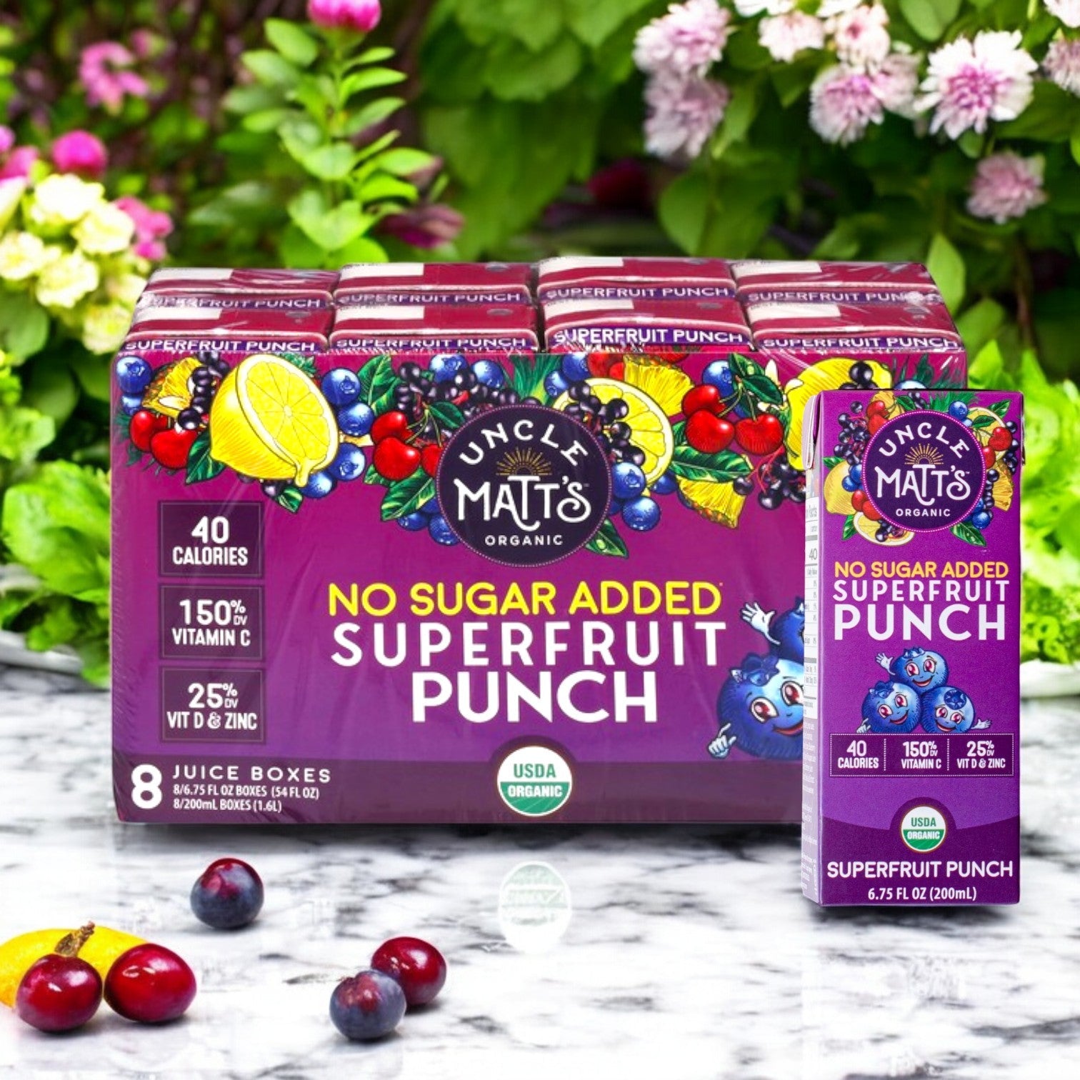 A pack of eight 6.75 fl oz Uncle Matt's Organic Superfruit Punch juice boxes, boasting "No Sugar Added" and "USDA Organic" tags, enriched with antioxidants and vitamins, surrounded by colorful fruits and pink flowers.