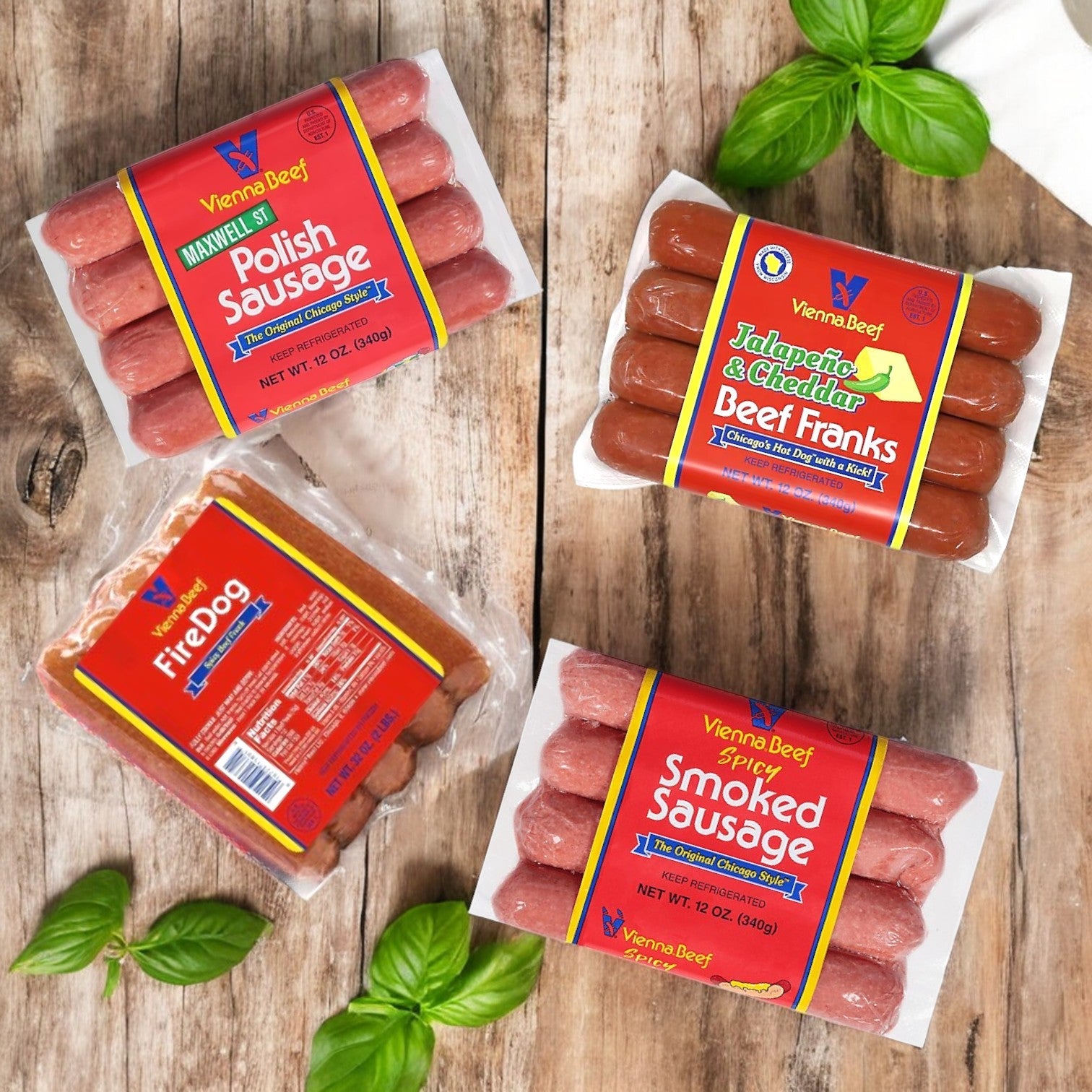 Displayed with a basil garnish, the Vienna Beef Variety Pack offers four packs of sausages, including 100% premium beef options like Maxwell St. Polish Sausage, Vienna Beef Franks, Jalapeño & Cheddar Beef Franks, and Spicy Smoked Sausage—capturing an authentic Chicago-style taste.