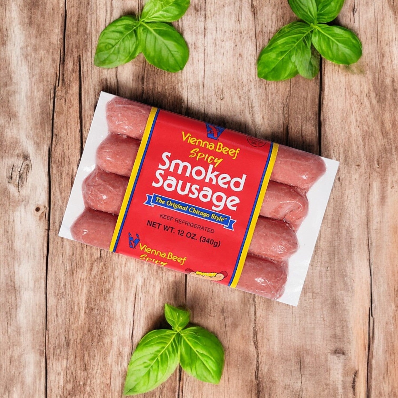 The Vienna Beef Variety Pack – A Classic Selection of Chicago’s Finest Sausages is placed on a wooden surface, surrounded by fresh basil leaves.