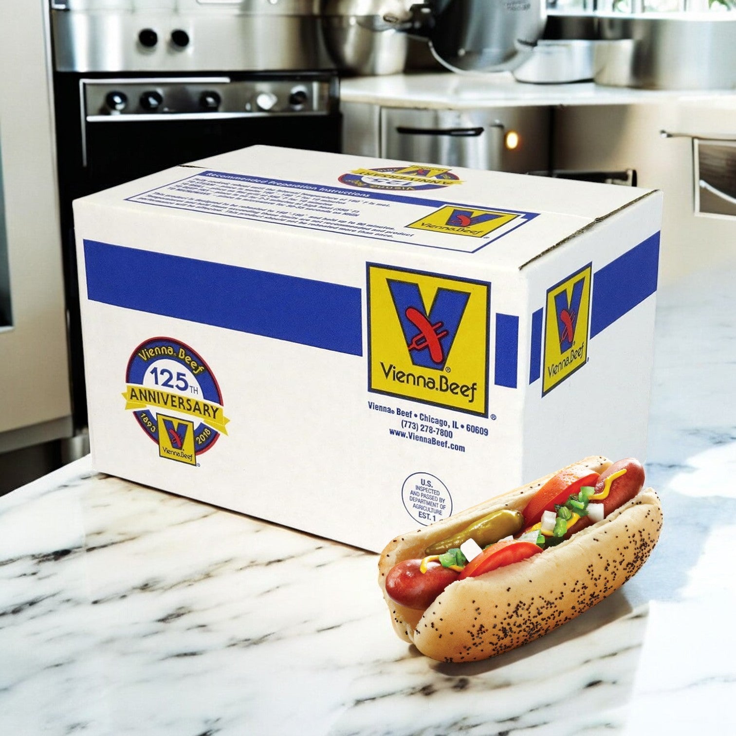 A Vienna Beef Natural Casing Franks 6" 10 Pound Box rests on the counter, featuring a hot dog in a poppy seed bun with colorful relish, onions, and peppers.