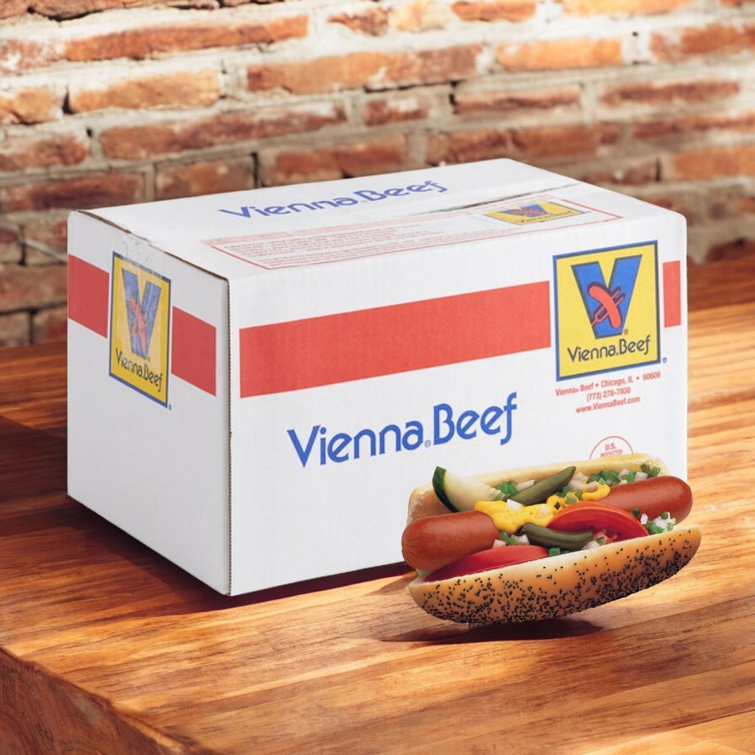 A Vienna Beef Hot Dog Kit box, containing 60 hot dogs and 60 buns, is placed on a wooden table next to a classic Chicago-style hot dog nestled in Rotella’s Poppyseed Buns. The hot dog is topped with mustard, onions, relish, a pickle, tomatoes, and peppers, all set against a rustic brick wall backdrop.