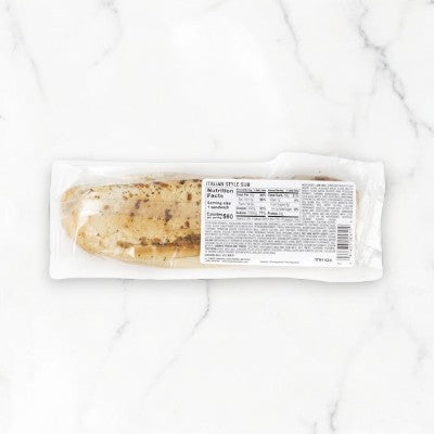 Artisan Italian Style Sub by E.A. Sween features smoked white turkey and Provolone cheese, with a dash of zesty Italian dressing, set on a white marble surface. Available in cases of 10 and shipped frozen with a 30-day cooler shelf life once thawed.