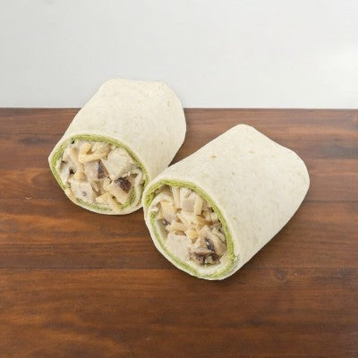 Two E.A. Sween Chicken Caesar Wraps, featuring tender grilled chicken and creamy Caesar dressing, neatly cut in half and displayed on a wooden surface; each wrap is individually packed - ships frozen with a 30-day shelf life once out of the freezer!.