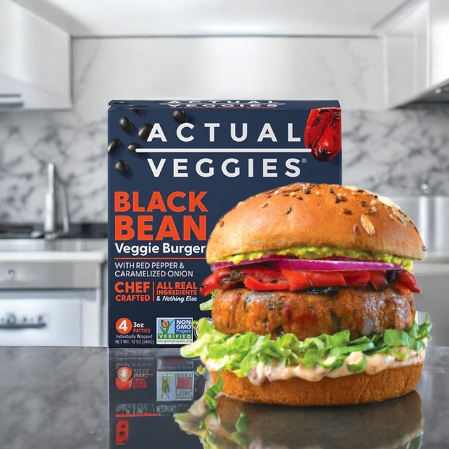 An Actual Veggies black bean burger with red pepper and onion is displayed on a kitchen counter beside its packaging, ideal for those embracing a plant-based lifestyle.