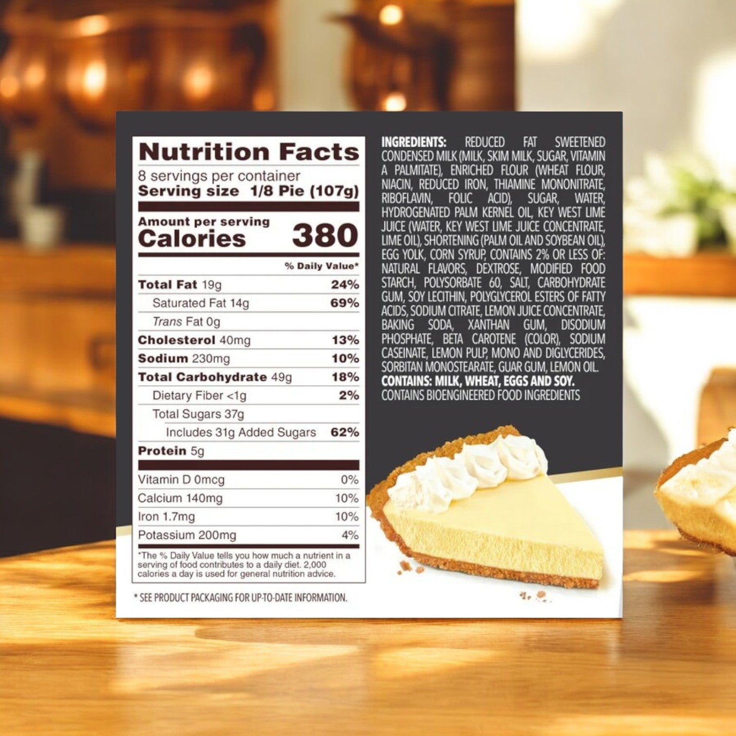 On a kitchen counter, a box of Edwards Desserts' Key Lime Pie-3 Count highlights nutrition facts and ingredients. In the foreground, a vibrant slice showcases the dessert's creamy texture, capturing the essence of frozen desserts with its graham cracker crust.