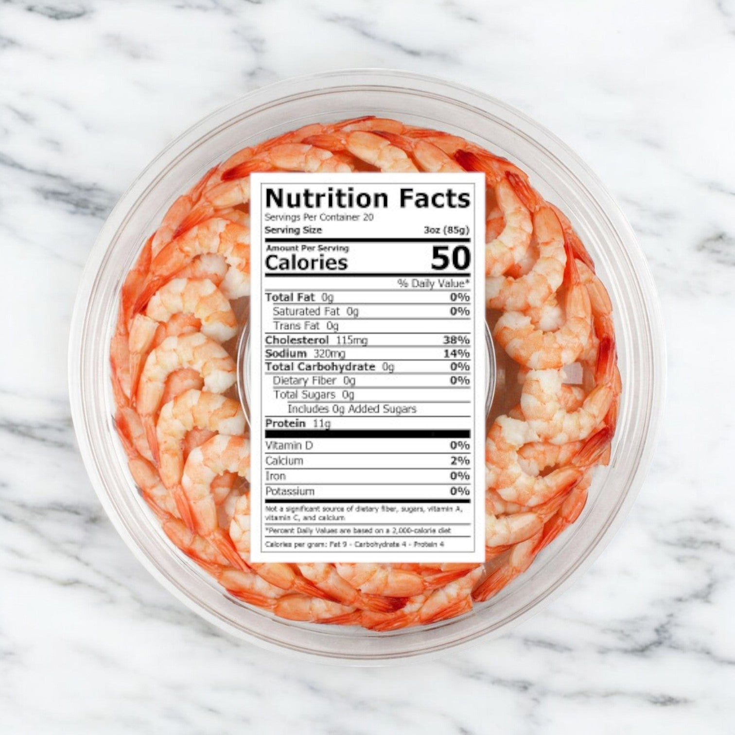 The Shrimp Platter by Sea Mazz is a 16 oz. fully cooked cocktail shrimp ring, elegantly arranged in a plastic container with a clear lid displaying the nutrition facts, offering convenience for your next gathering.