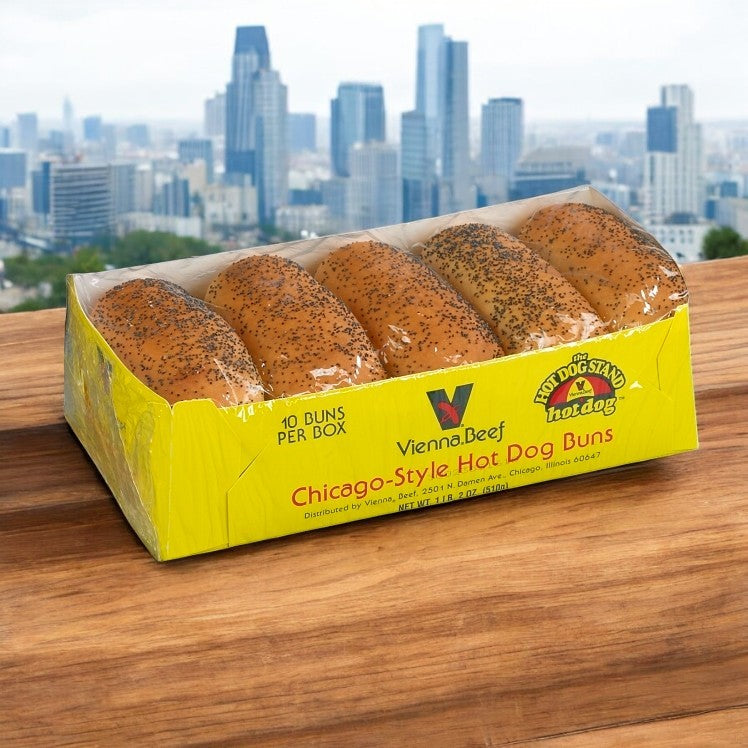A package of Vienna Beef Hot Dog Buns, White Poppy Seed 5" Sliced, rests on a wooden surface with a city skyline backdrop.