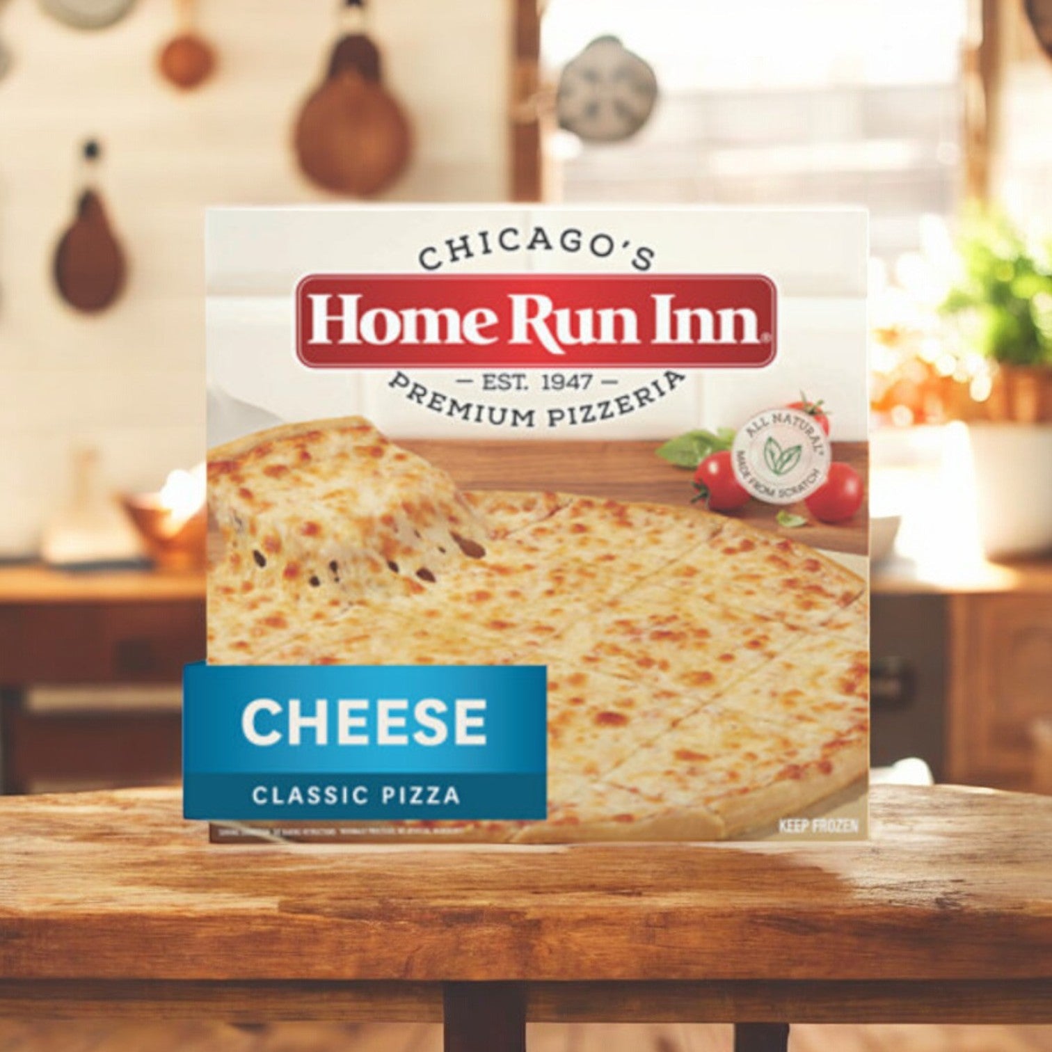 A 27 oz. Home Run Inn Family Size Cheese Pizza on a wooden kitchen counter with a blurred kitchen background, tempting you with its authentic pizzeria taste and rich mozzarella cheese layer.